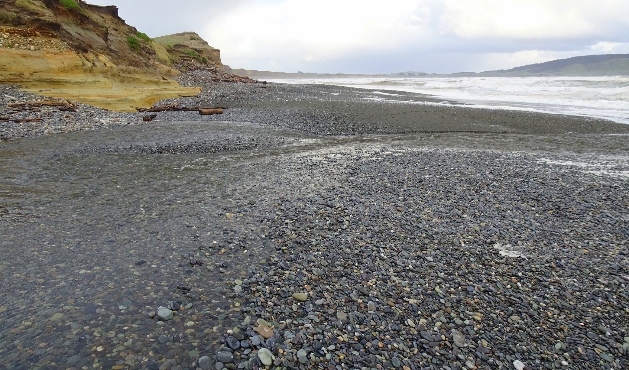 The Waimeamea River flowing across the beach. Photo taken after I had crossed it, looking south east.