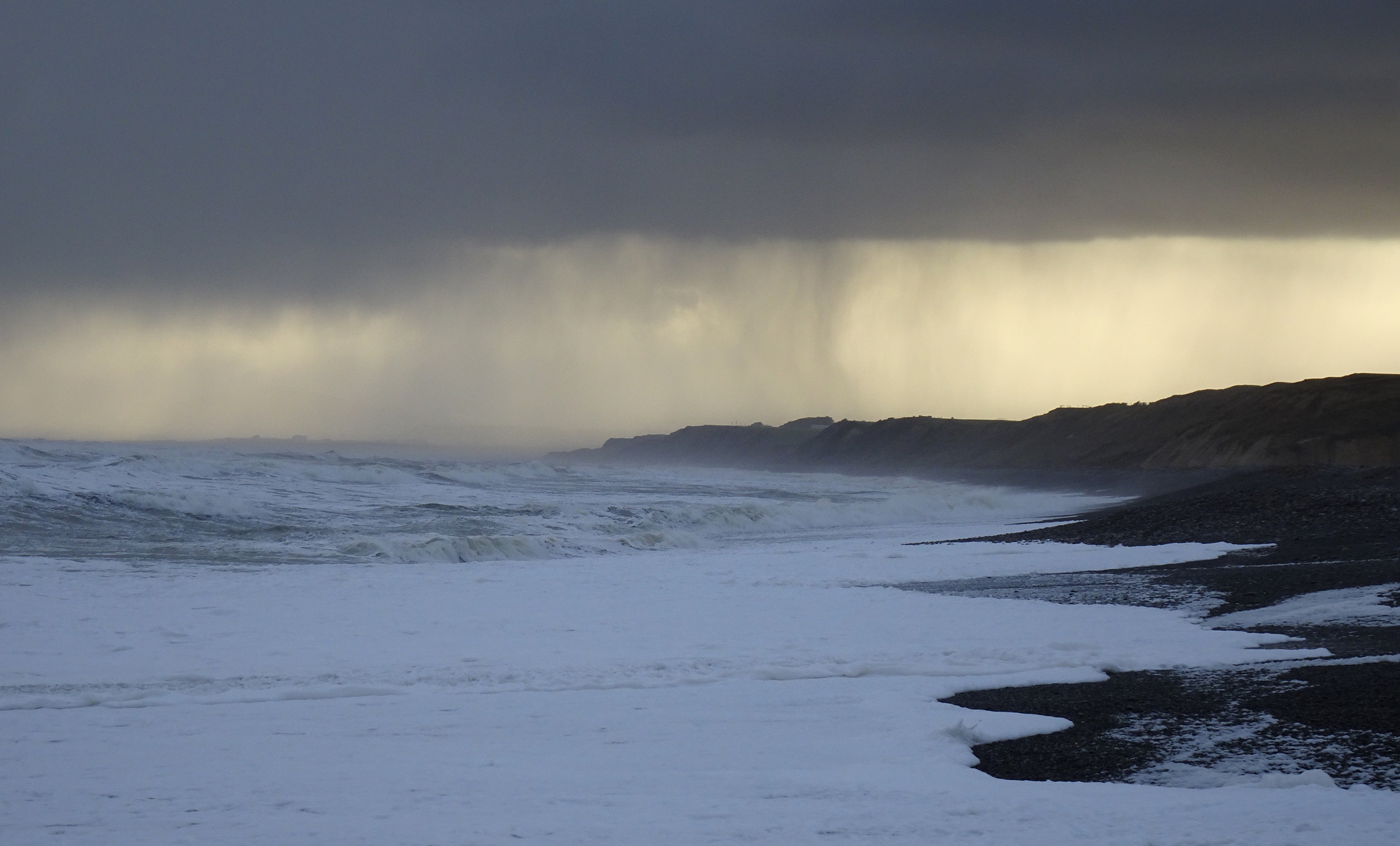 Rain passing in the distance to the west.