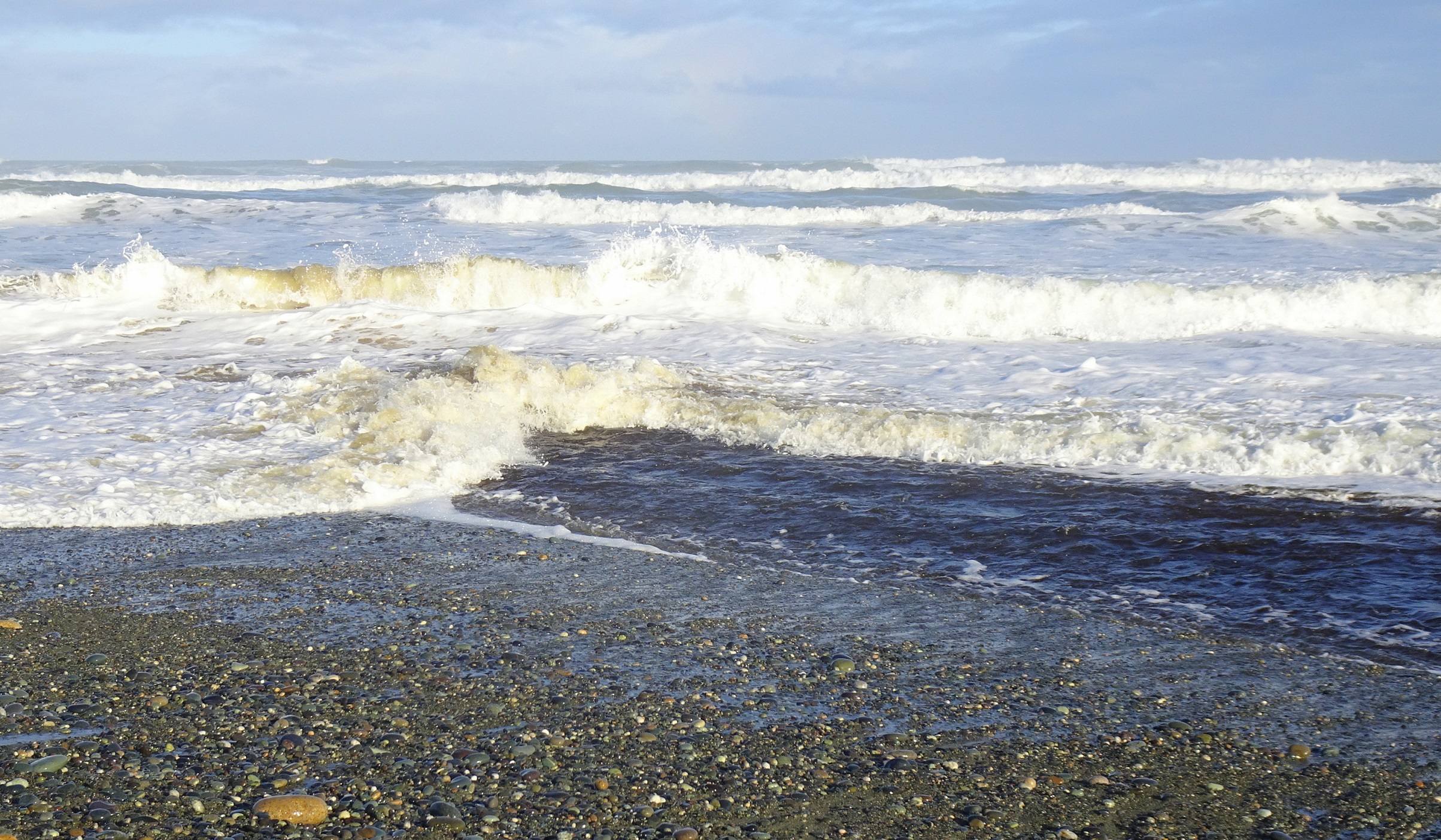 The unsettled sea at the river mouth.