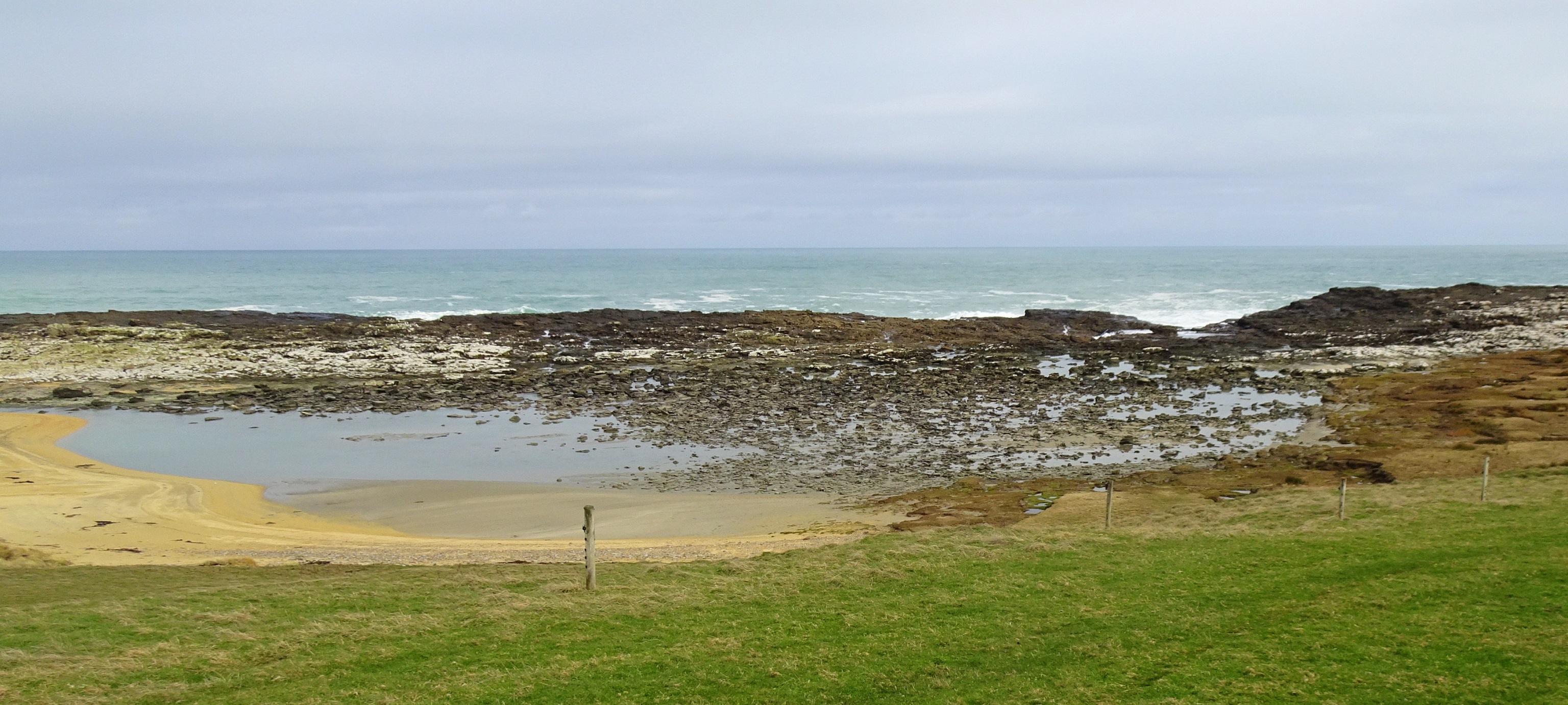The lagoon behind the sandy beach today - water draining away as the tide recedes.
