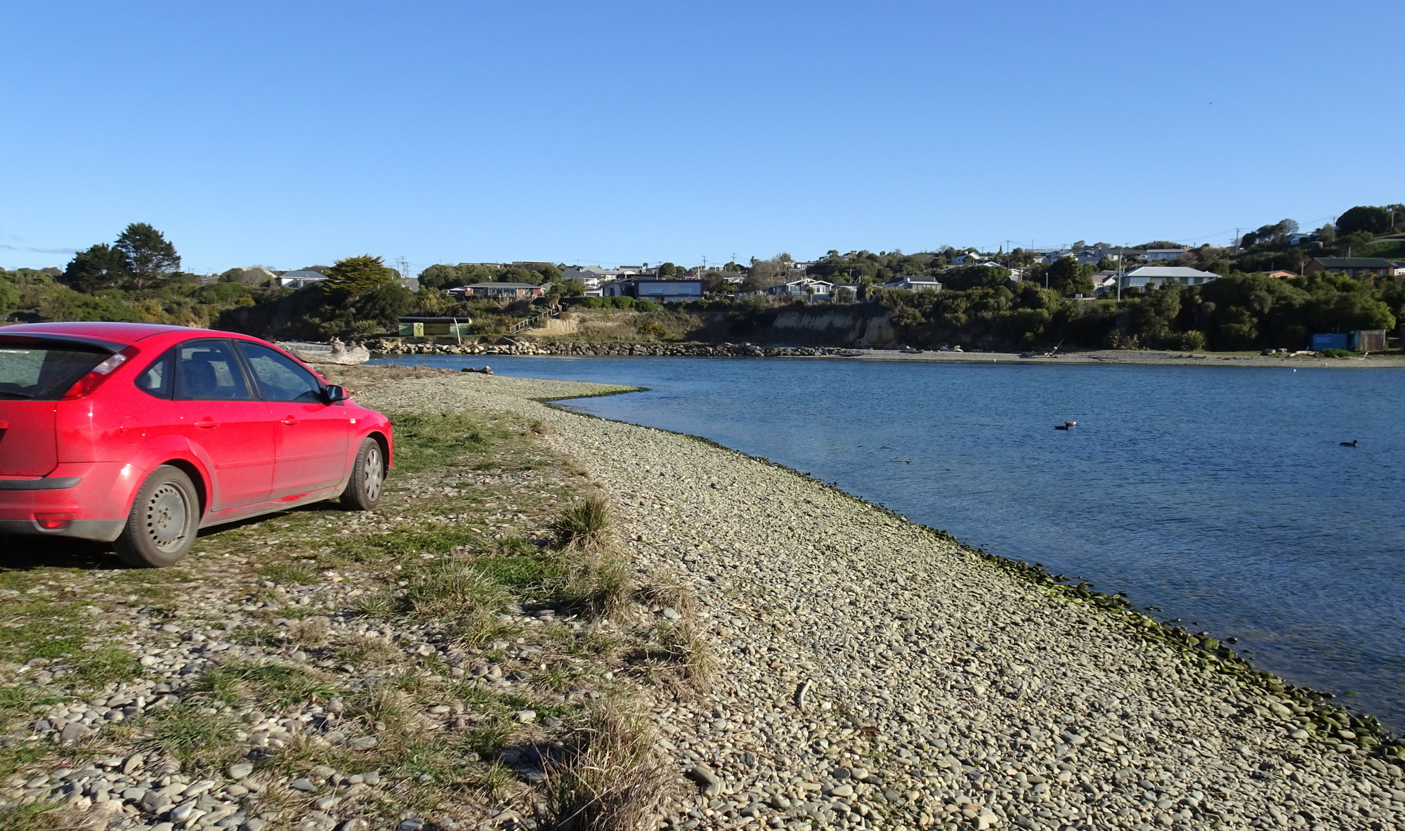 At the Kakanui River mouth, taking photos of my finds.