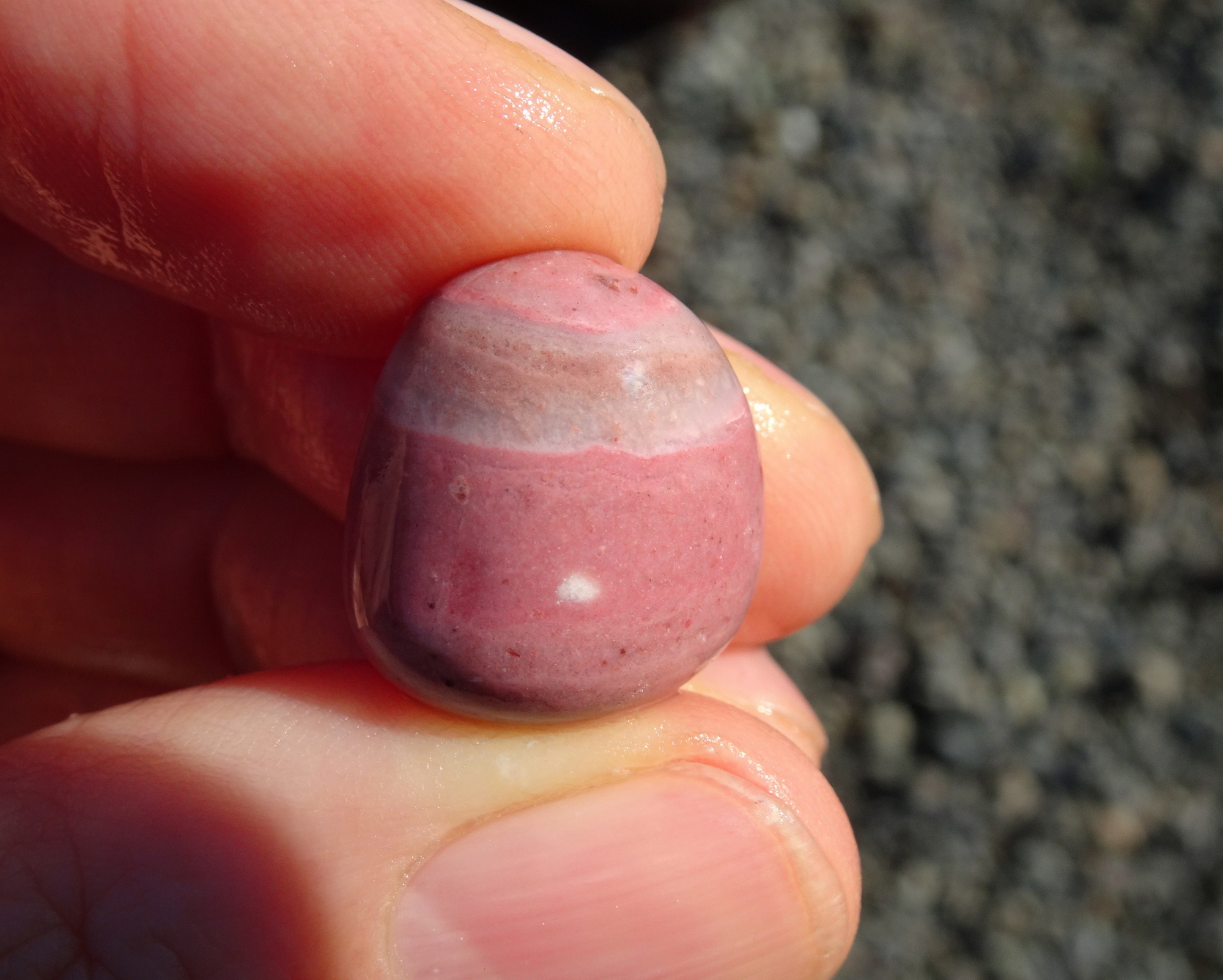 Small pink stone with whote spot.