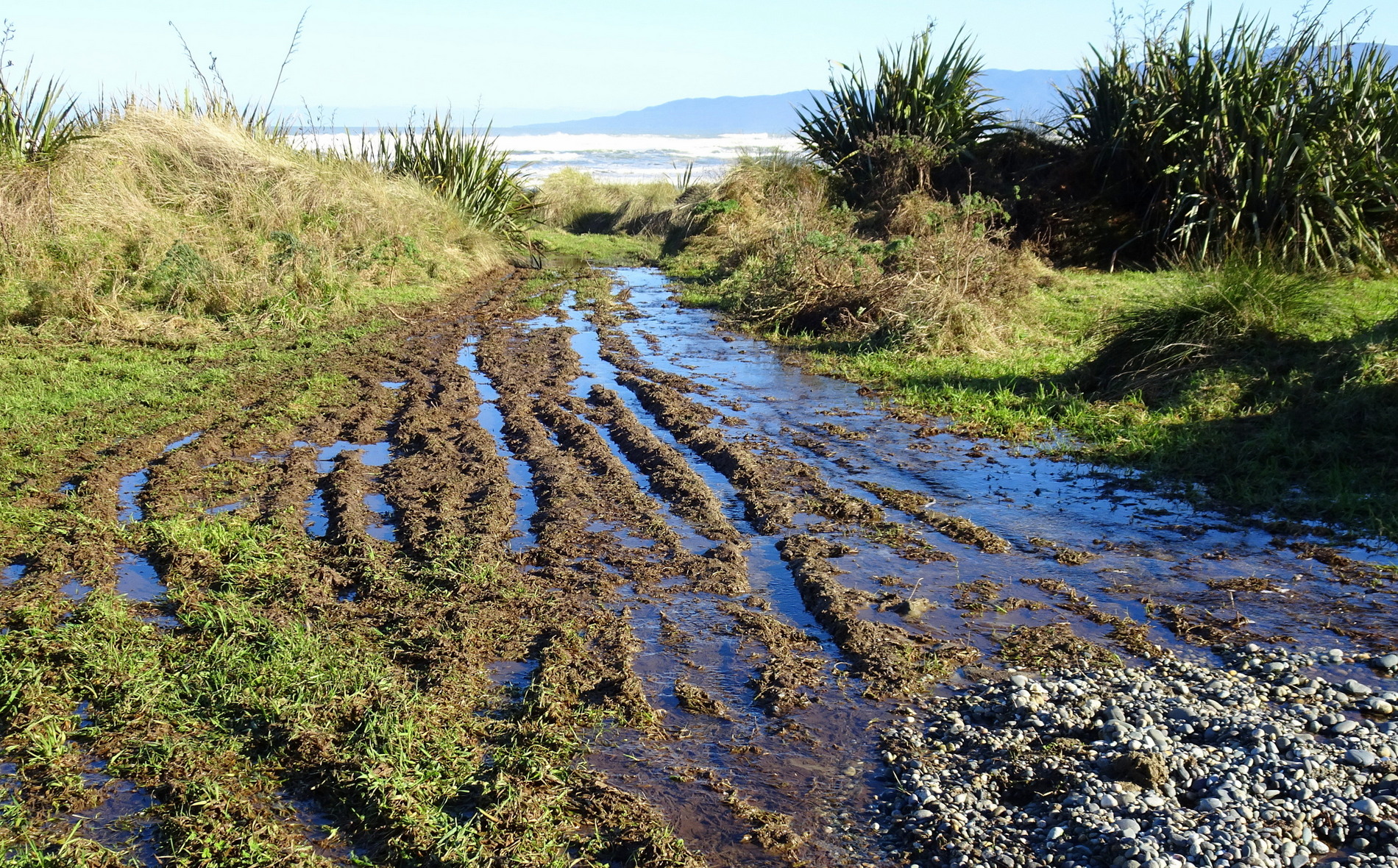 A very wet and muddy beach entrance.