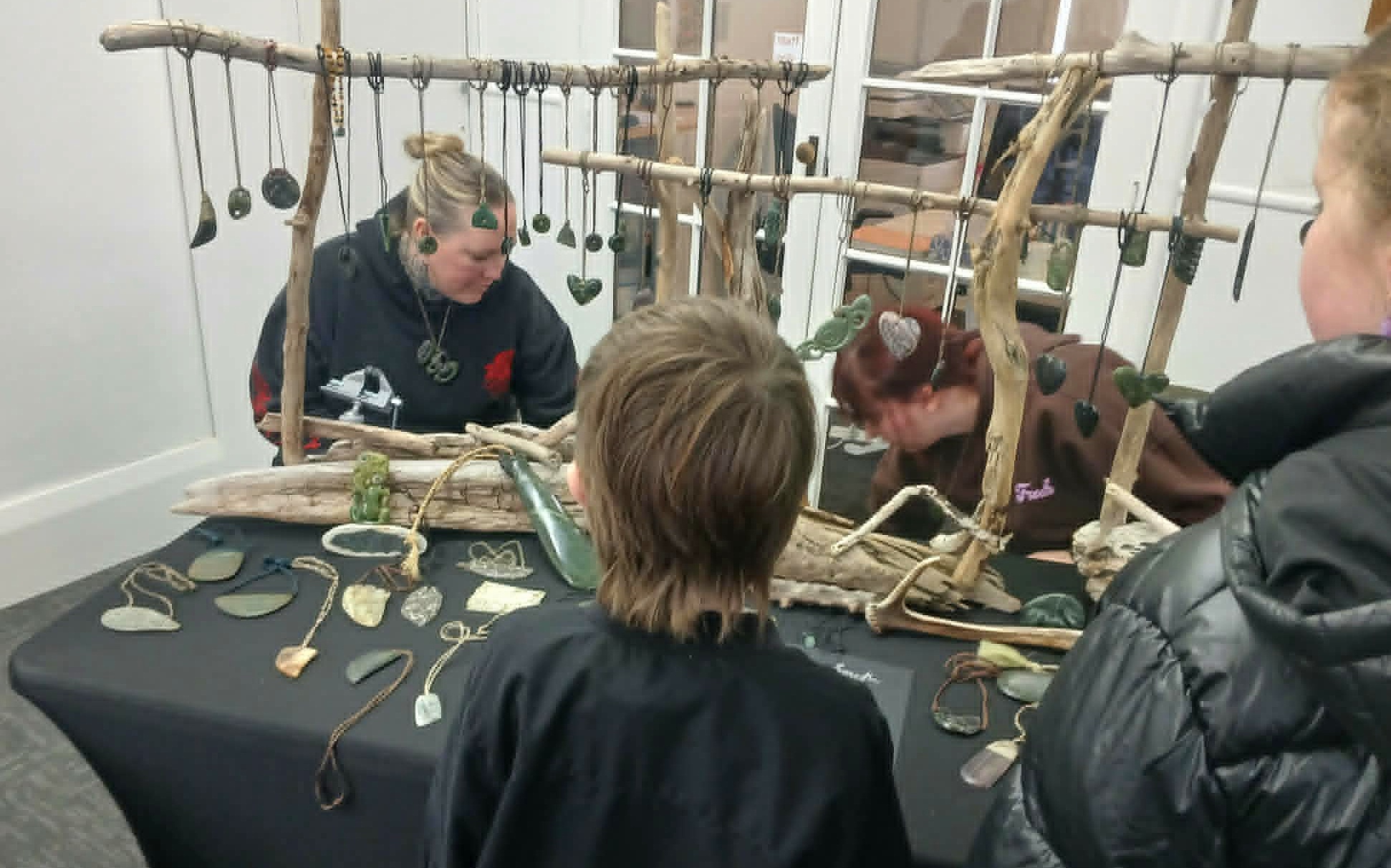 Michelle (left) and Amelia busy at the Deep South Pounamu table.