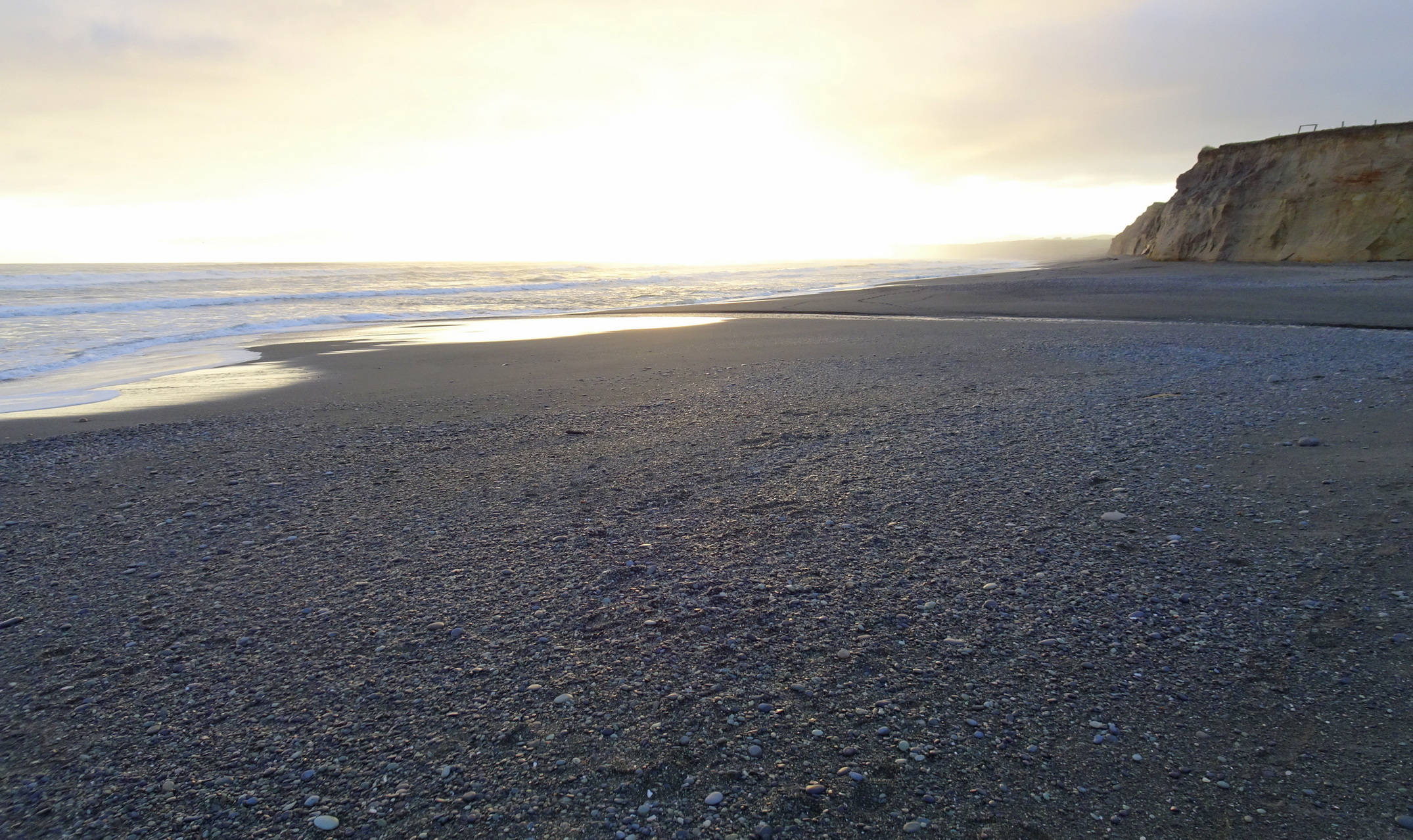 At the end of the fossick, looking back over the Taunoa Stream to the sun low in the sky.