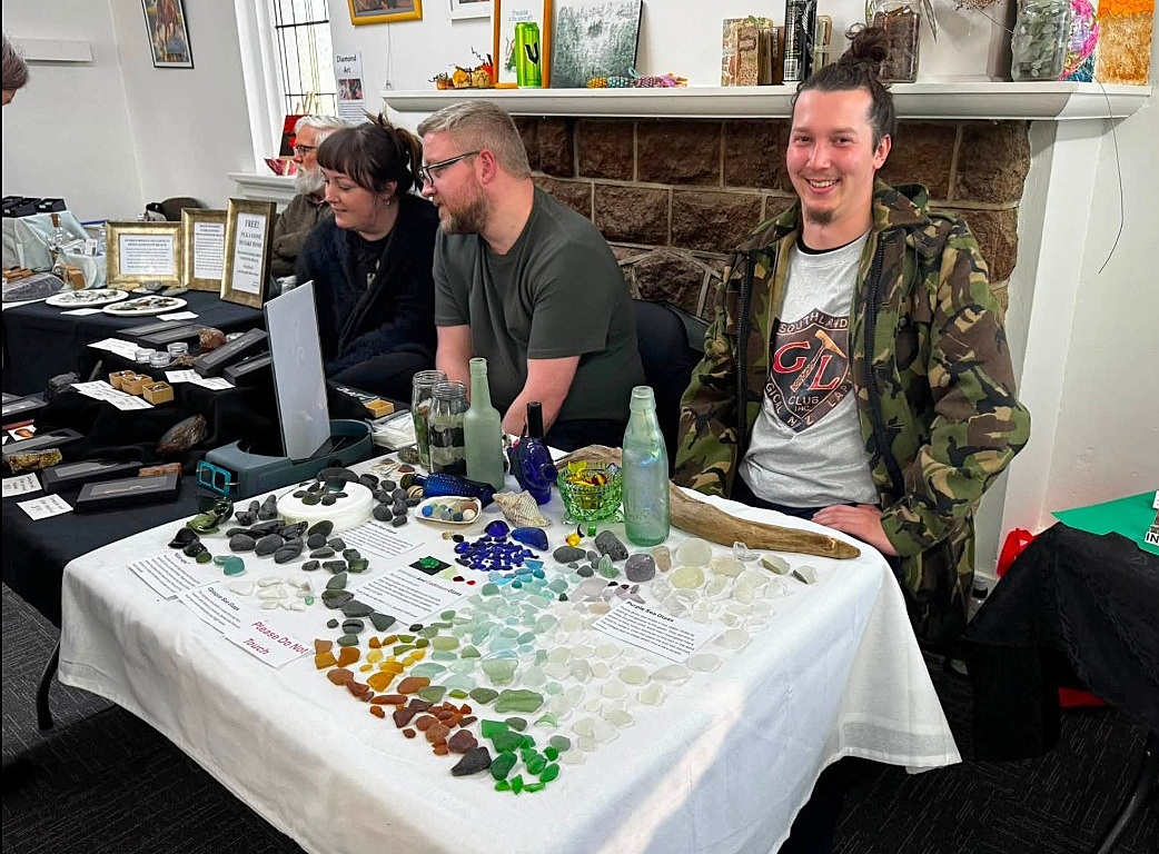 Kaleb's display of sea glass, with Sam and Sarah (and me) behind. Source: www.facebook.com/sglc.rocks.