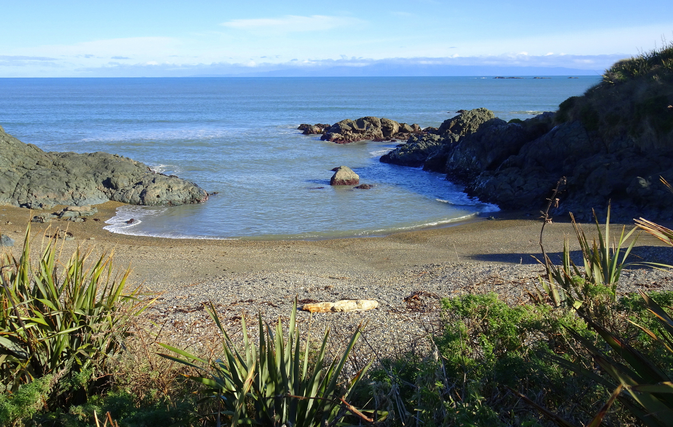 Small cove at western end.
