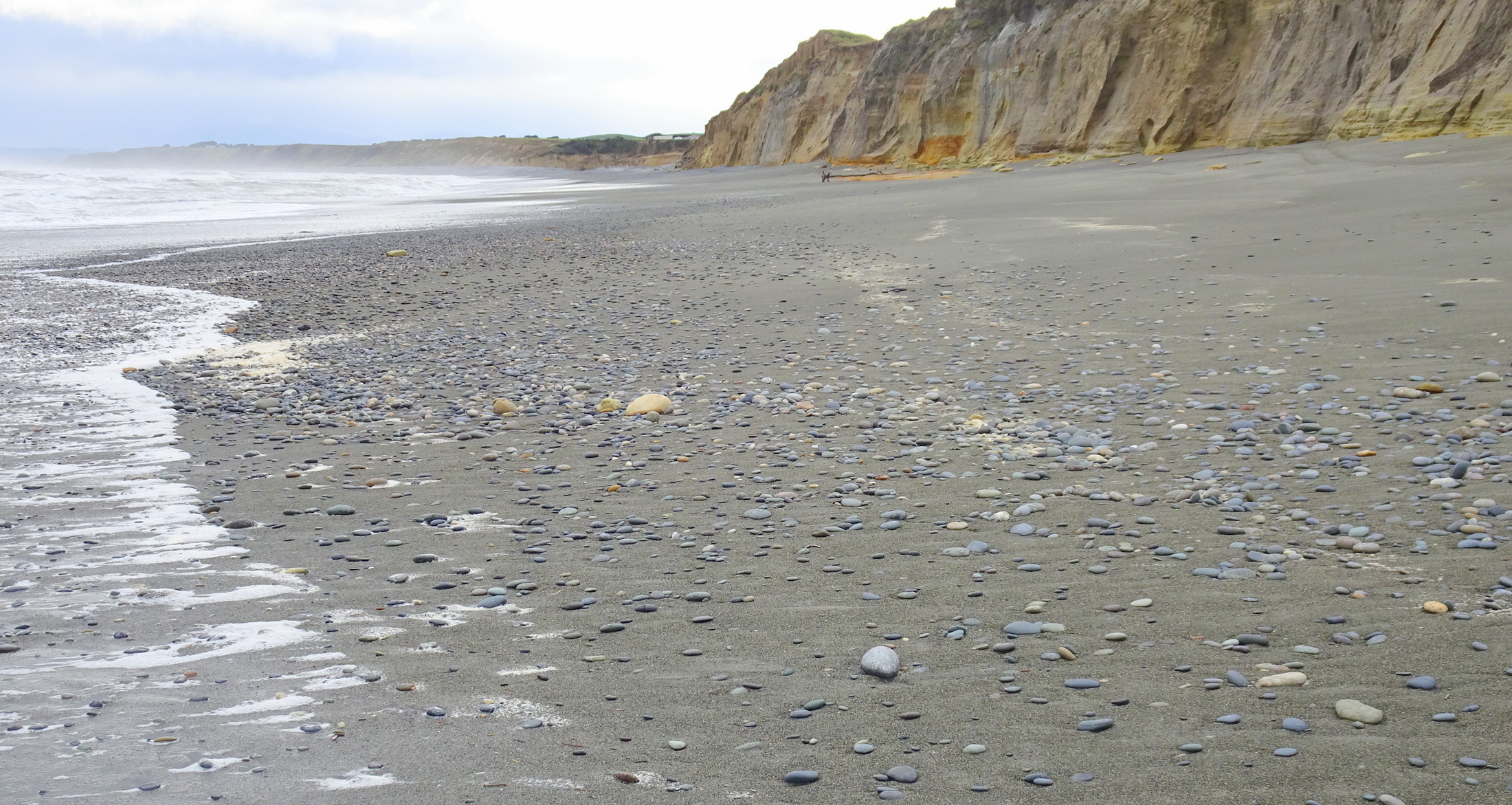 Stones along the beach on the other side of the Taunoa Stream.