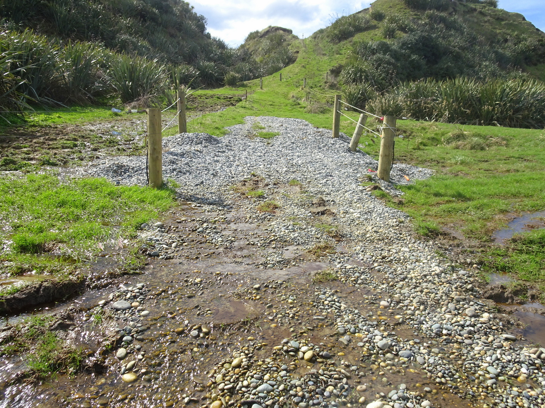 At the bottom of the track, looking back at a gravelled section.