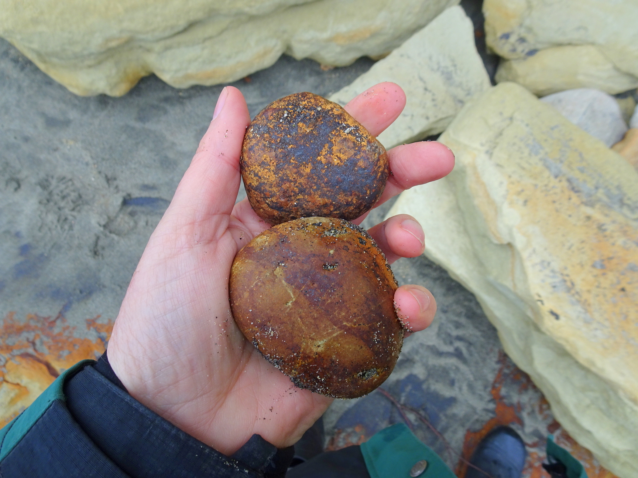 Iron-stained stones from the cliffs.