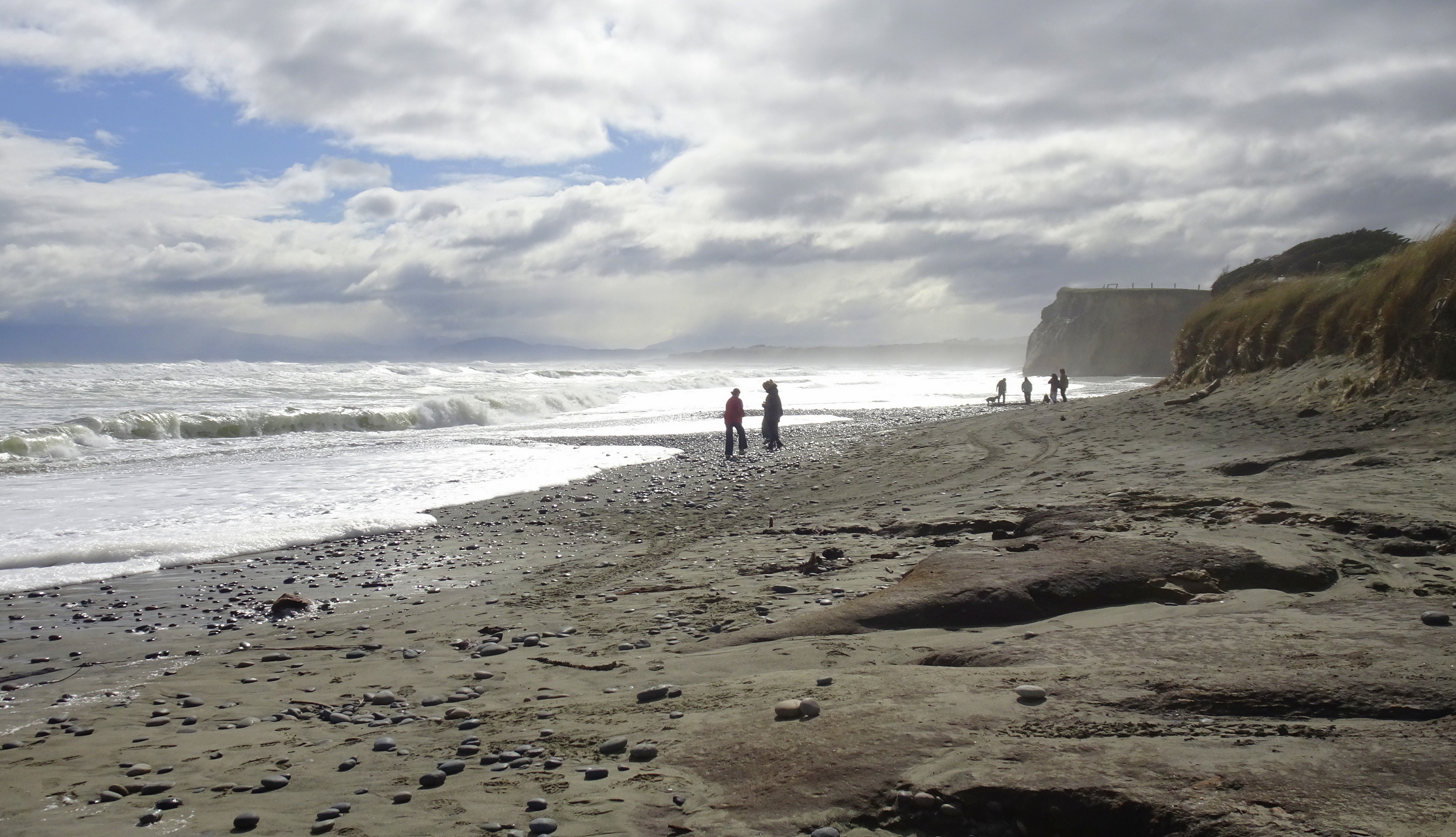 Waves were coming high up the beach and rain was threatening.