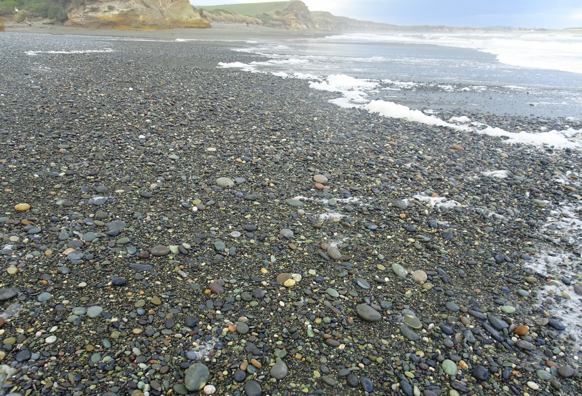 Looking back over the Taunoa Stream (middle distance) to the beach in front of the car park.