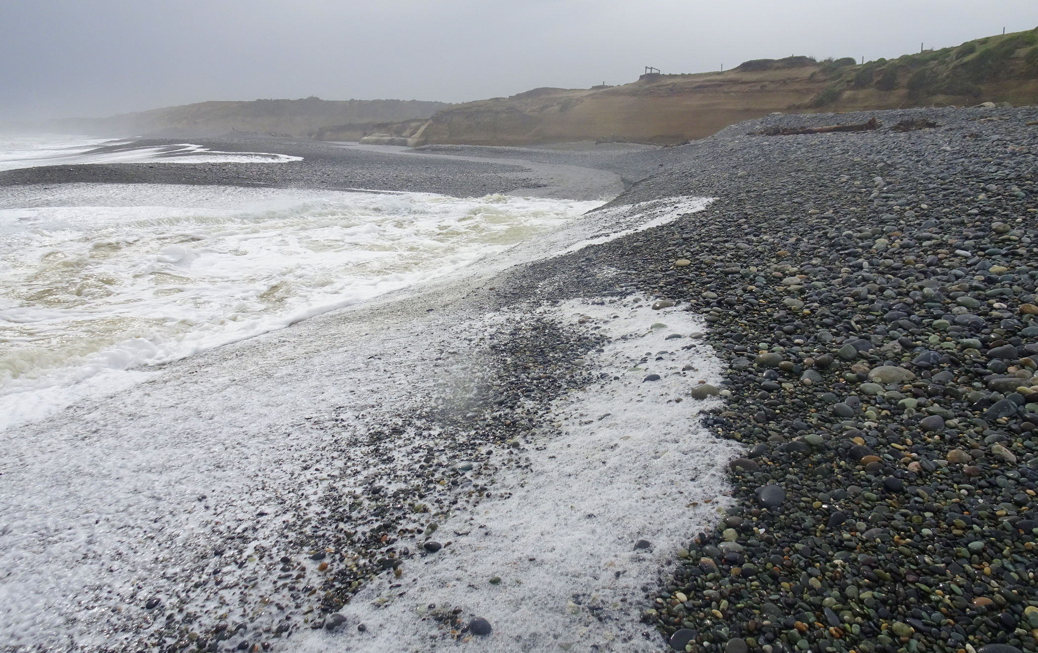 A wave going up the Waimeamea River at its mouth.