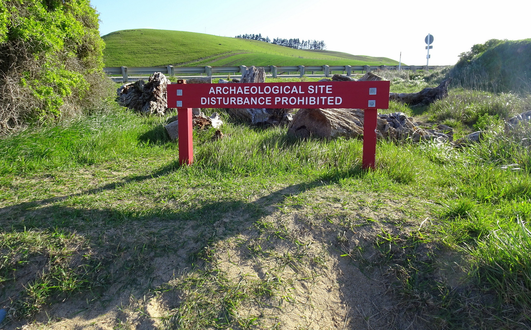 Beside the road closure.