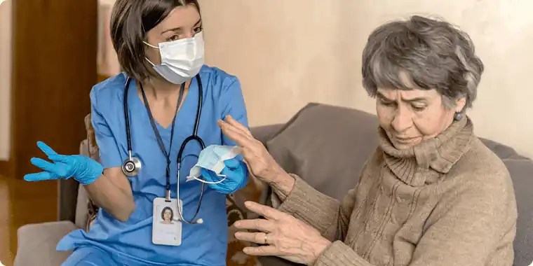 Elderly lady being cared for by a carer