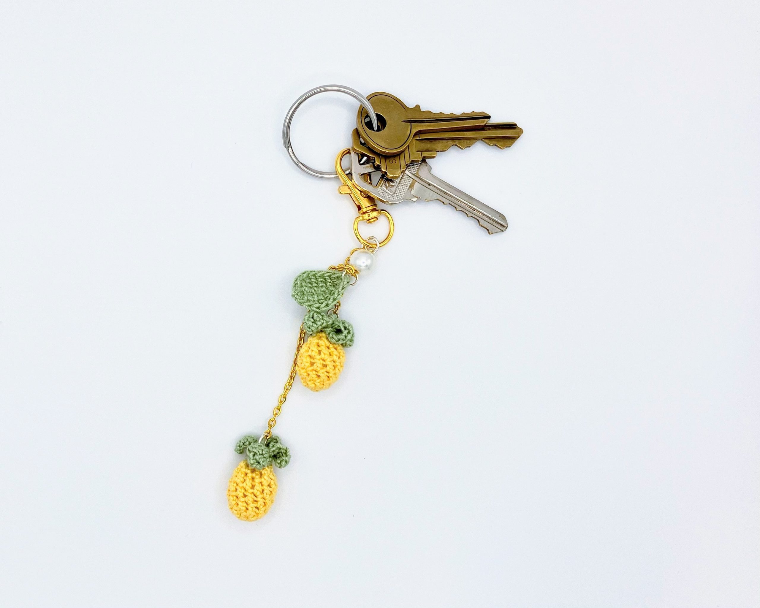 Crocheted pineapple keychain on a key ring with keys