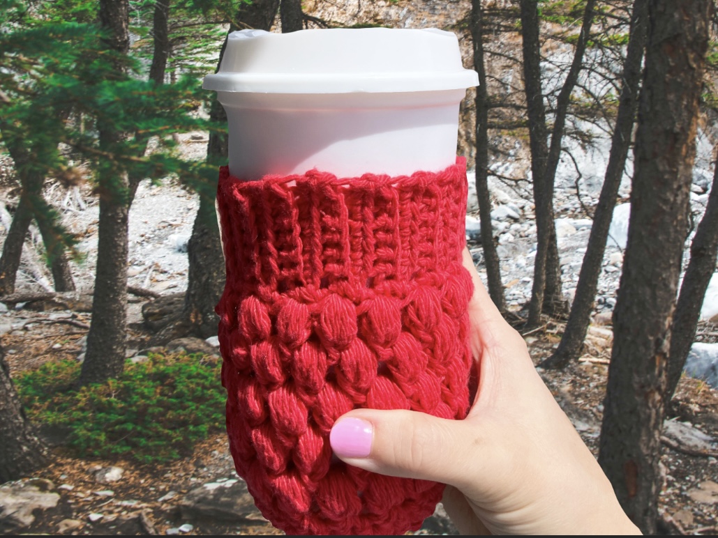 Red crochet cup cozy on white coffee cup