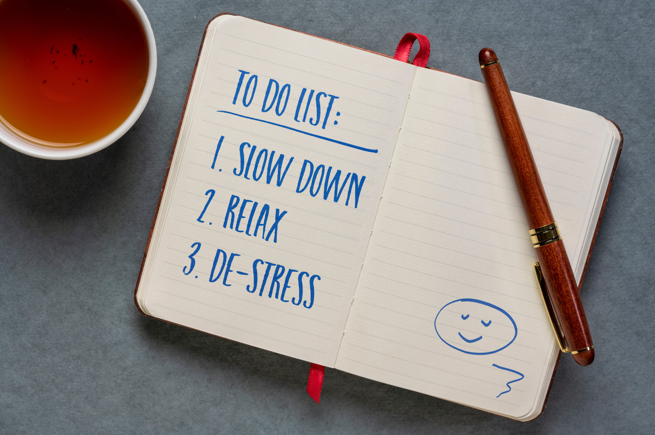 to do list - slow down, relax and de-stress, handwriting in a notebook or journal, journaling, lifestyle and personal development concept