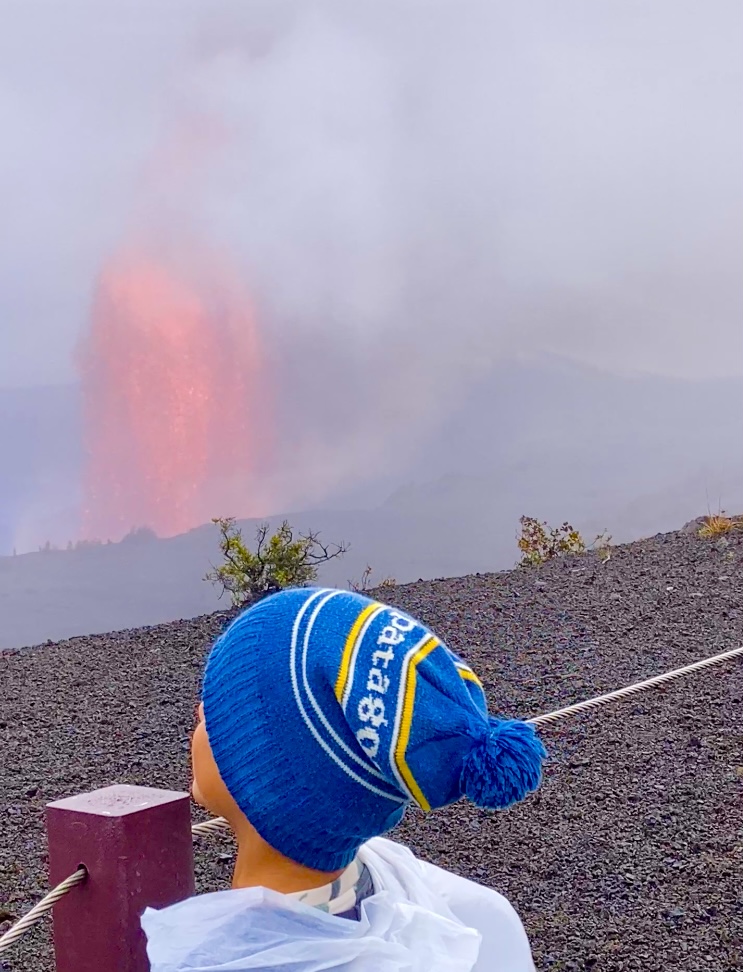 Kid in front of lava flow