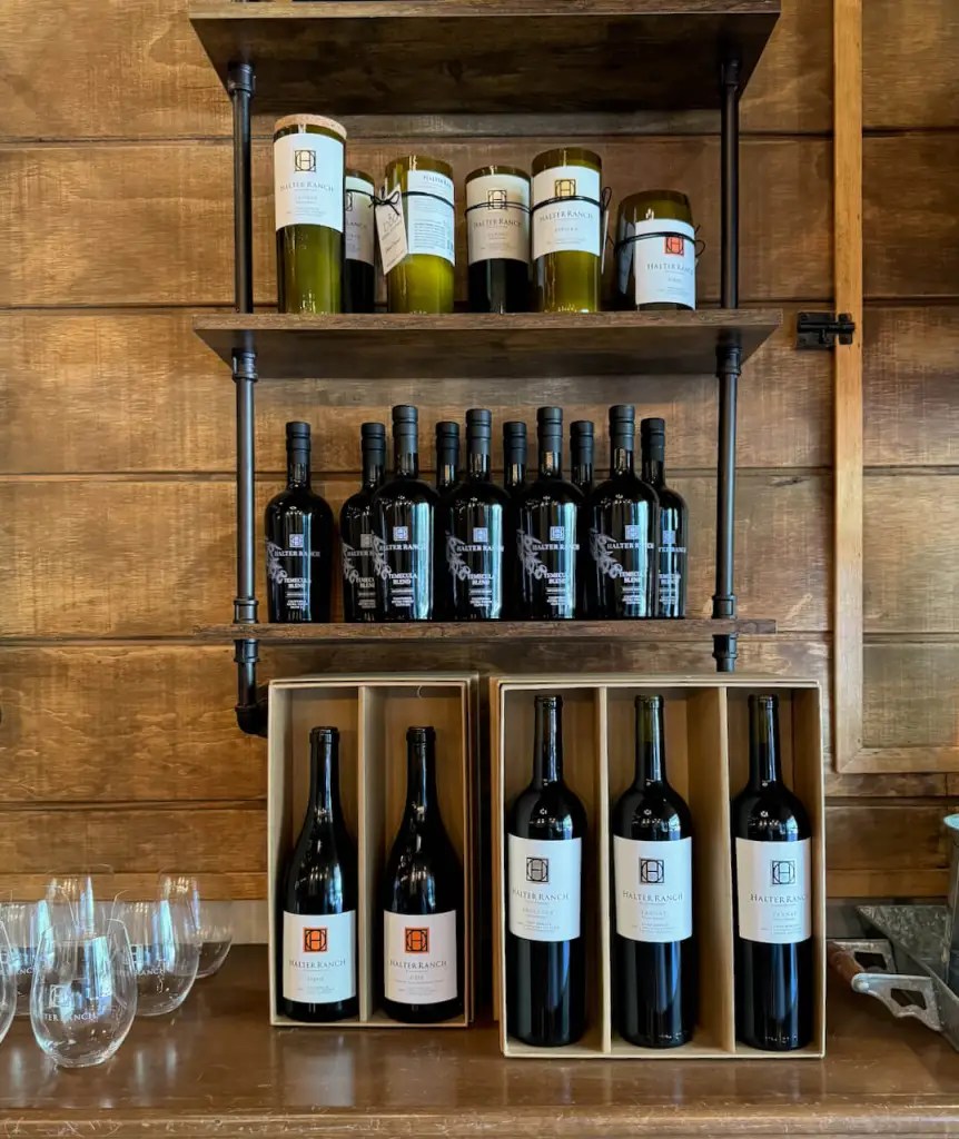 A shelf with wine bottles.