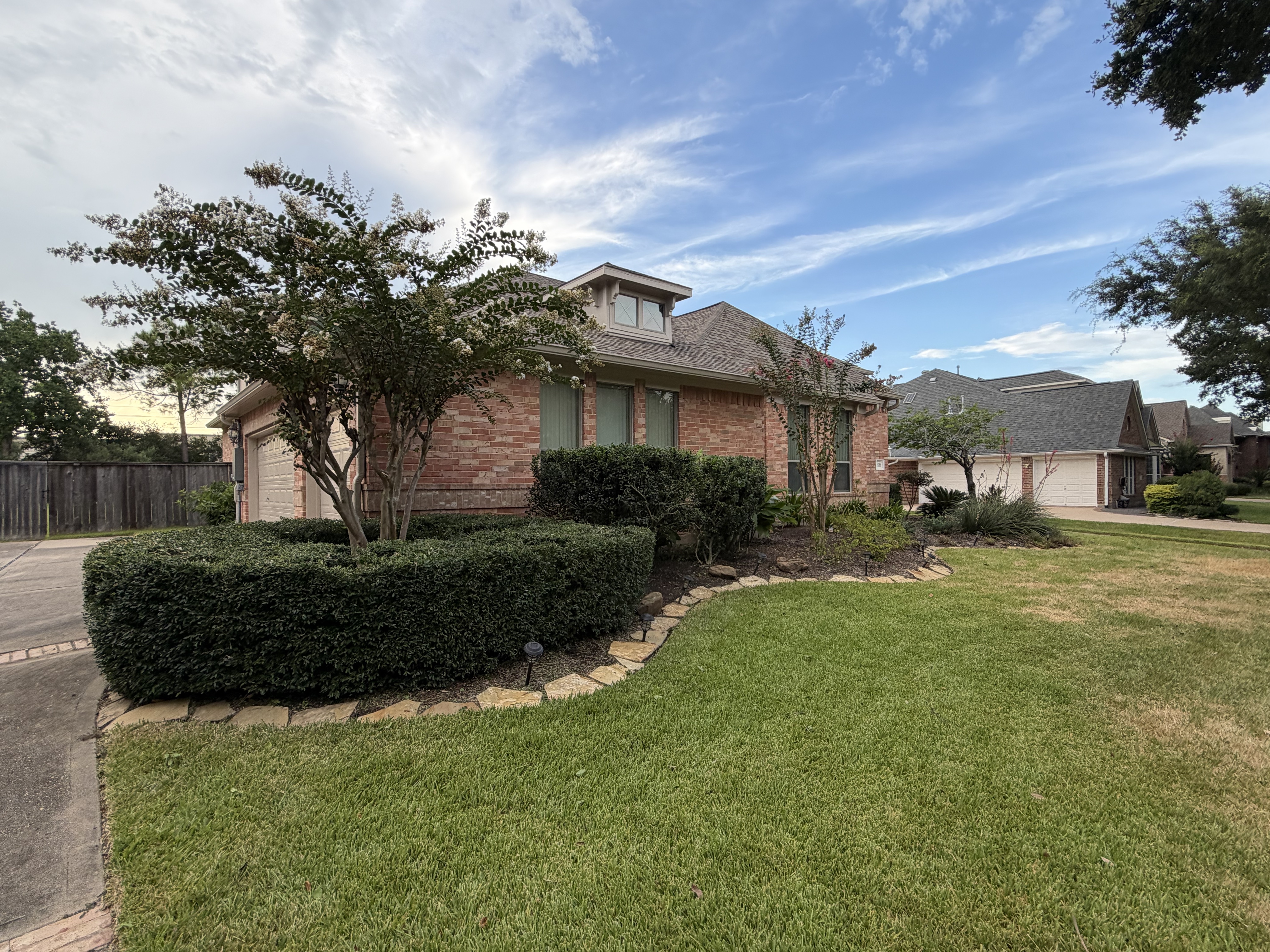 After: lush green lawn with crisply trimmed hedges in Katy, TX