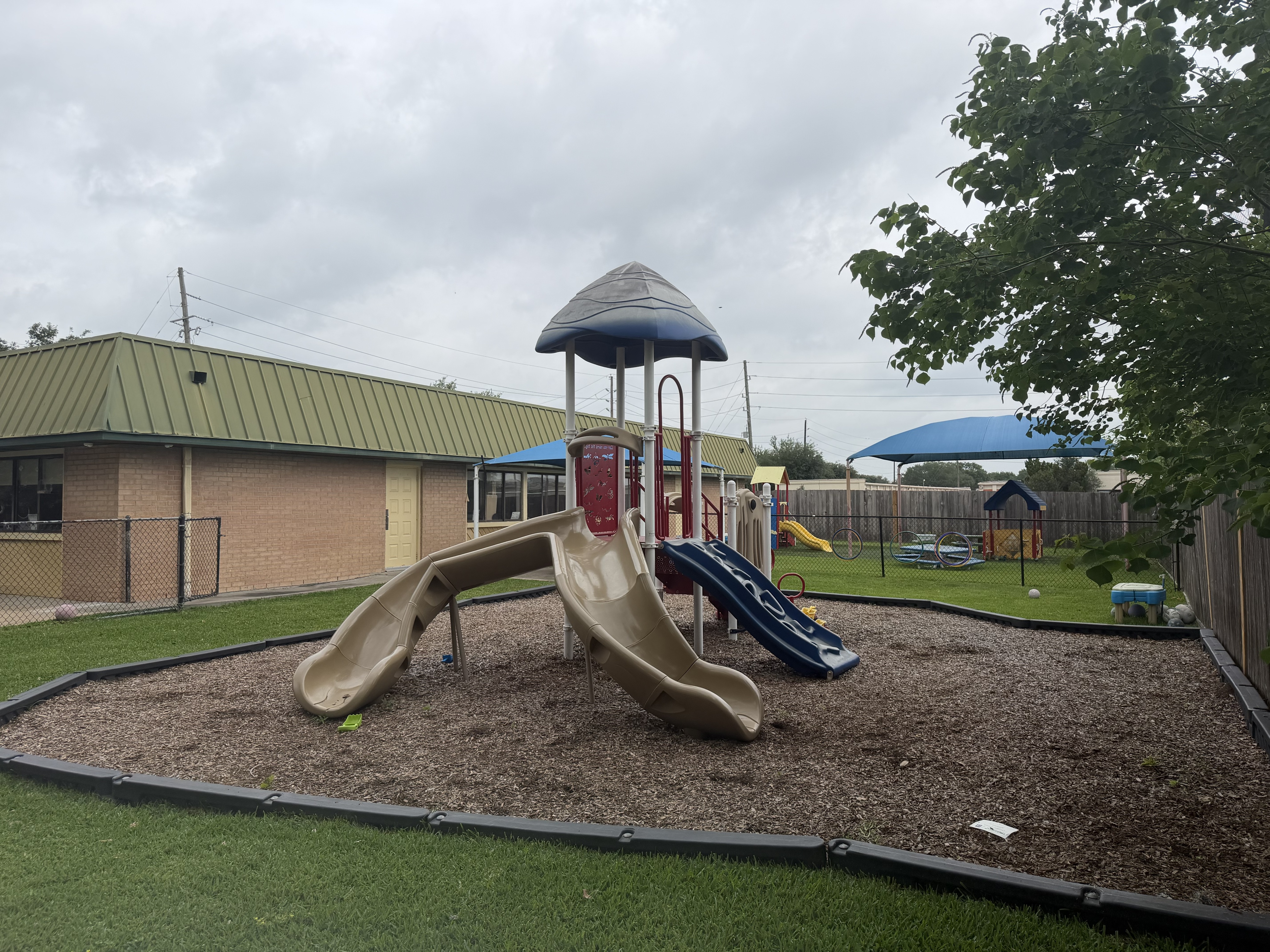 Before: worn, faded playground mulch bed