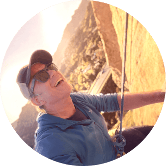 Paul Reid smiling while climbing
