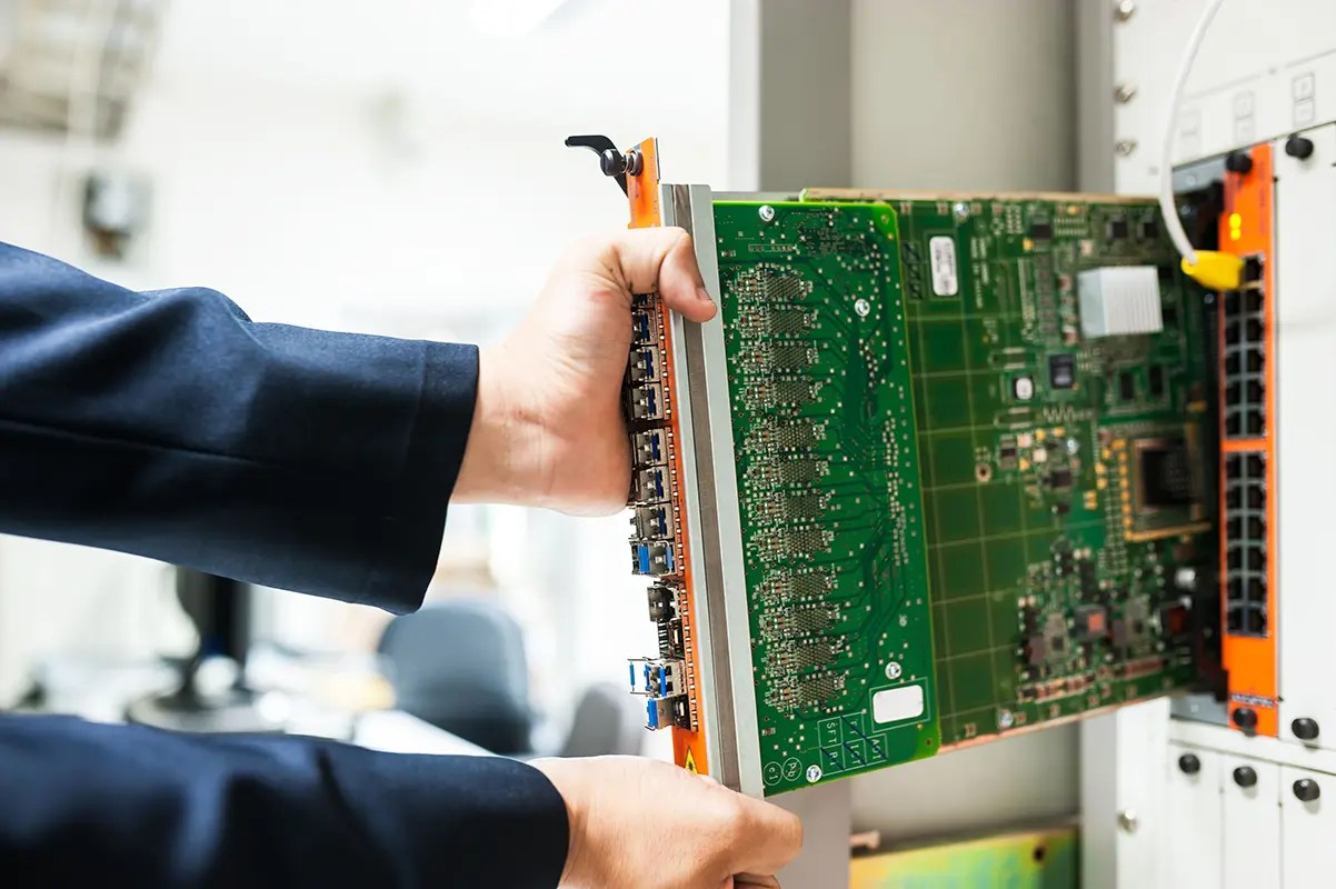 IT infrastructure engineer working on server rack equipment in a data centre
