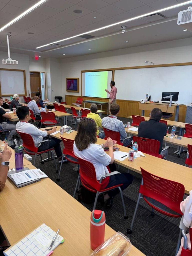 Nathan Rosenberg teaching in front of classroom full of people