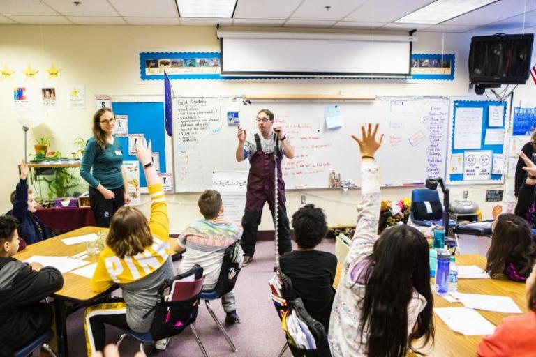 Someone gives a demonstration to a class of children.