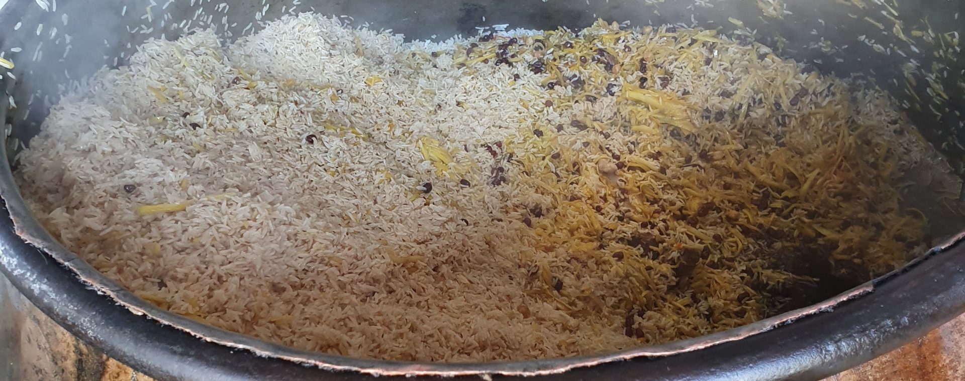plov with yellow carrots and raisins, bukhara, uzbekistan 2019