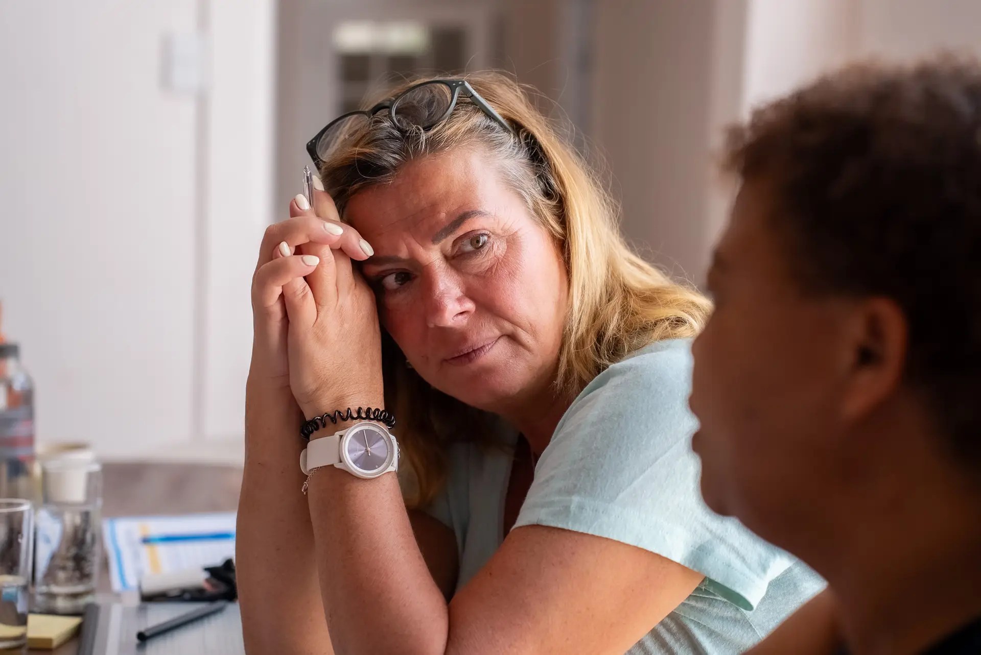 Participant listening attentively during a conversation exercise in a training
