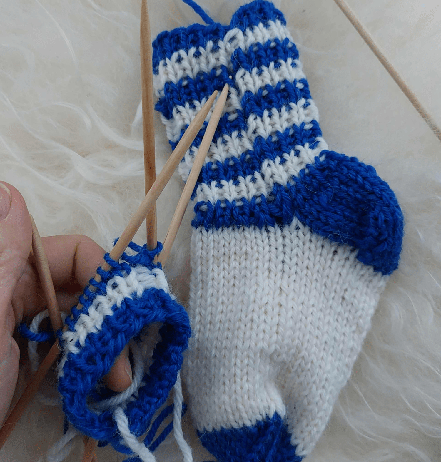 a woman knitting a basic pair of socks