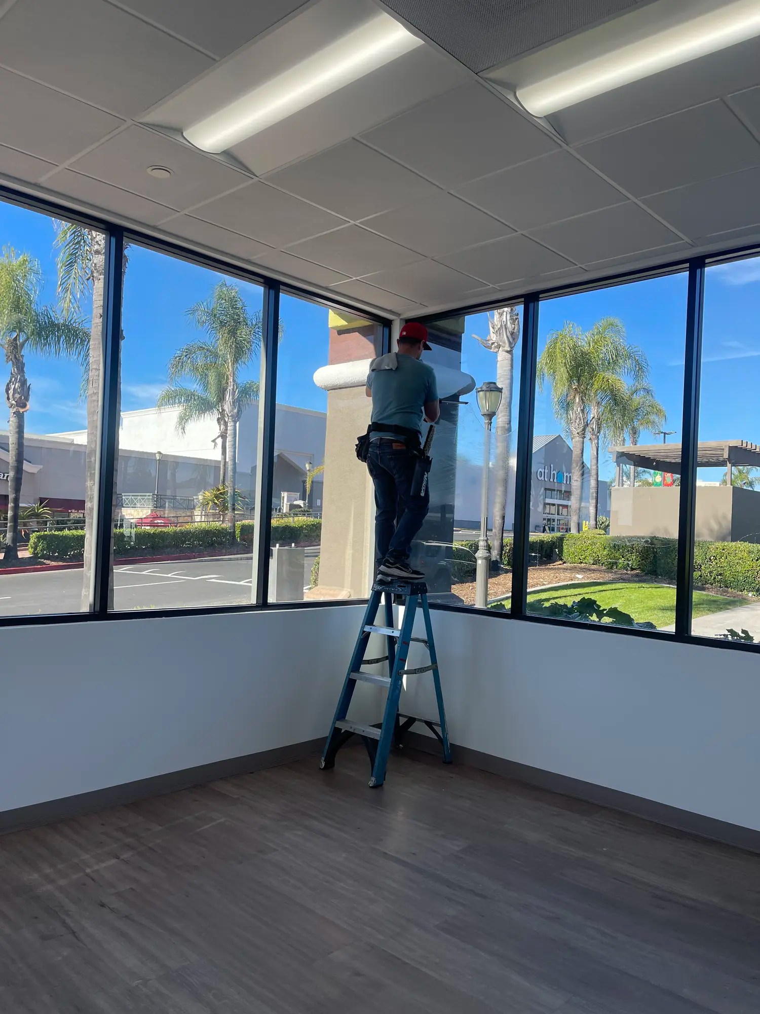 Commercial janitorial staff performing precision window and building maintenance for a San Diego facility