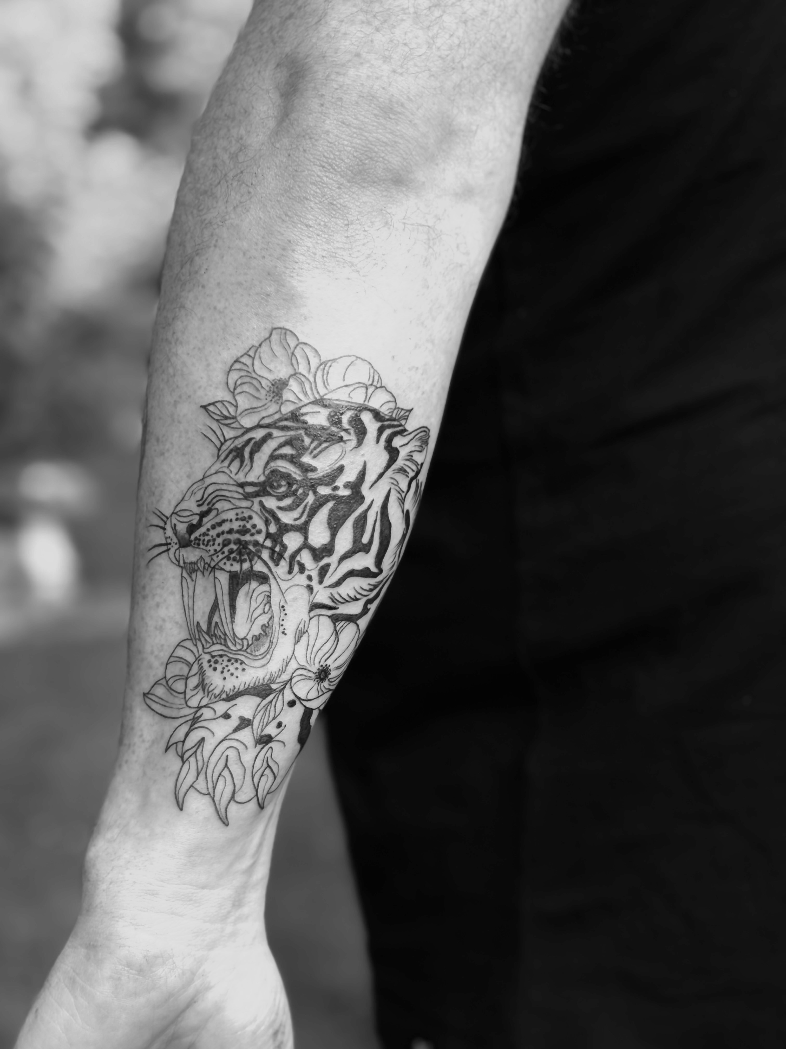Detailed tiger head tattoo on arm