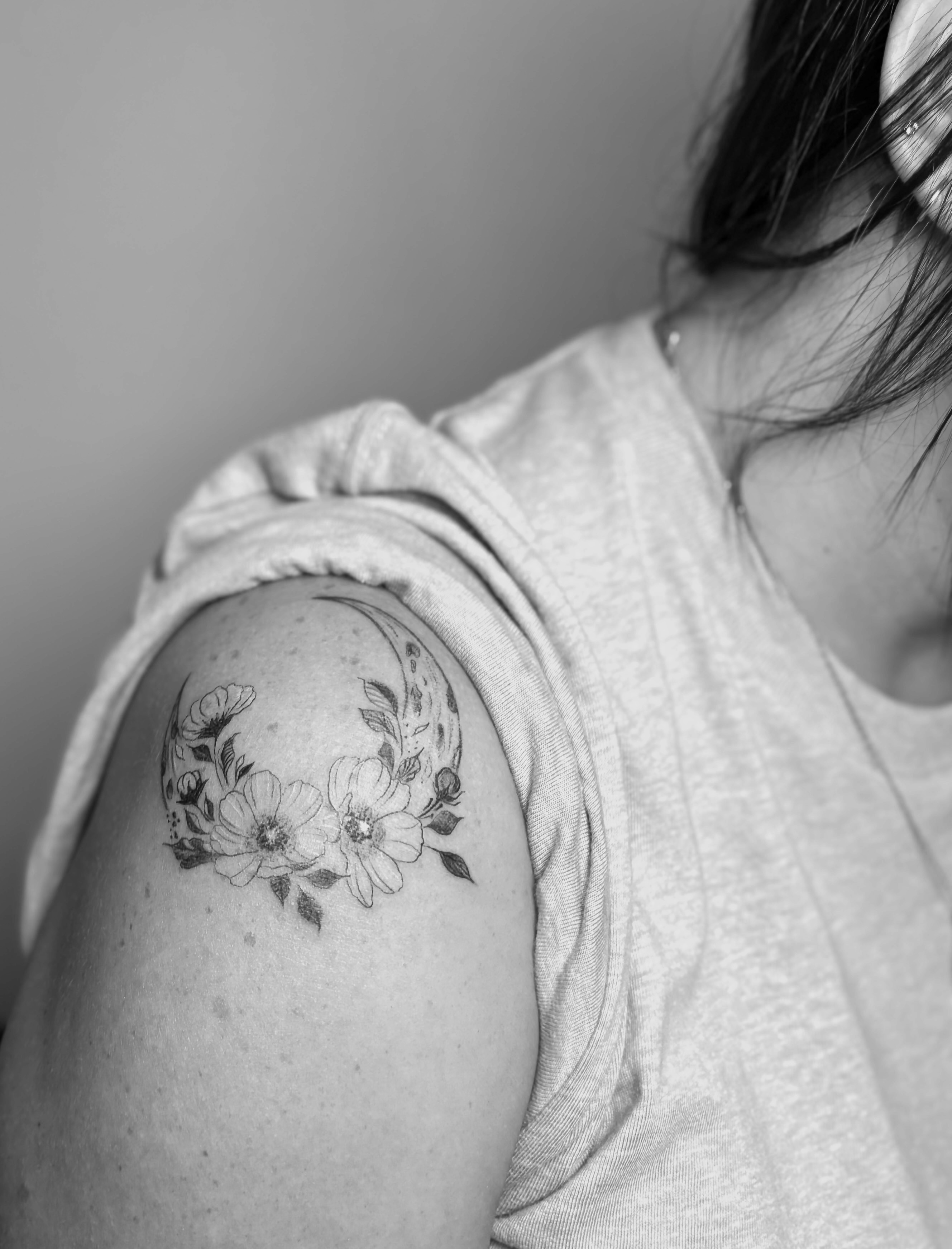 Small floral tattoo on shoulder