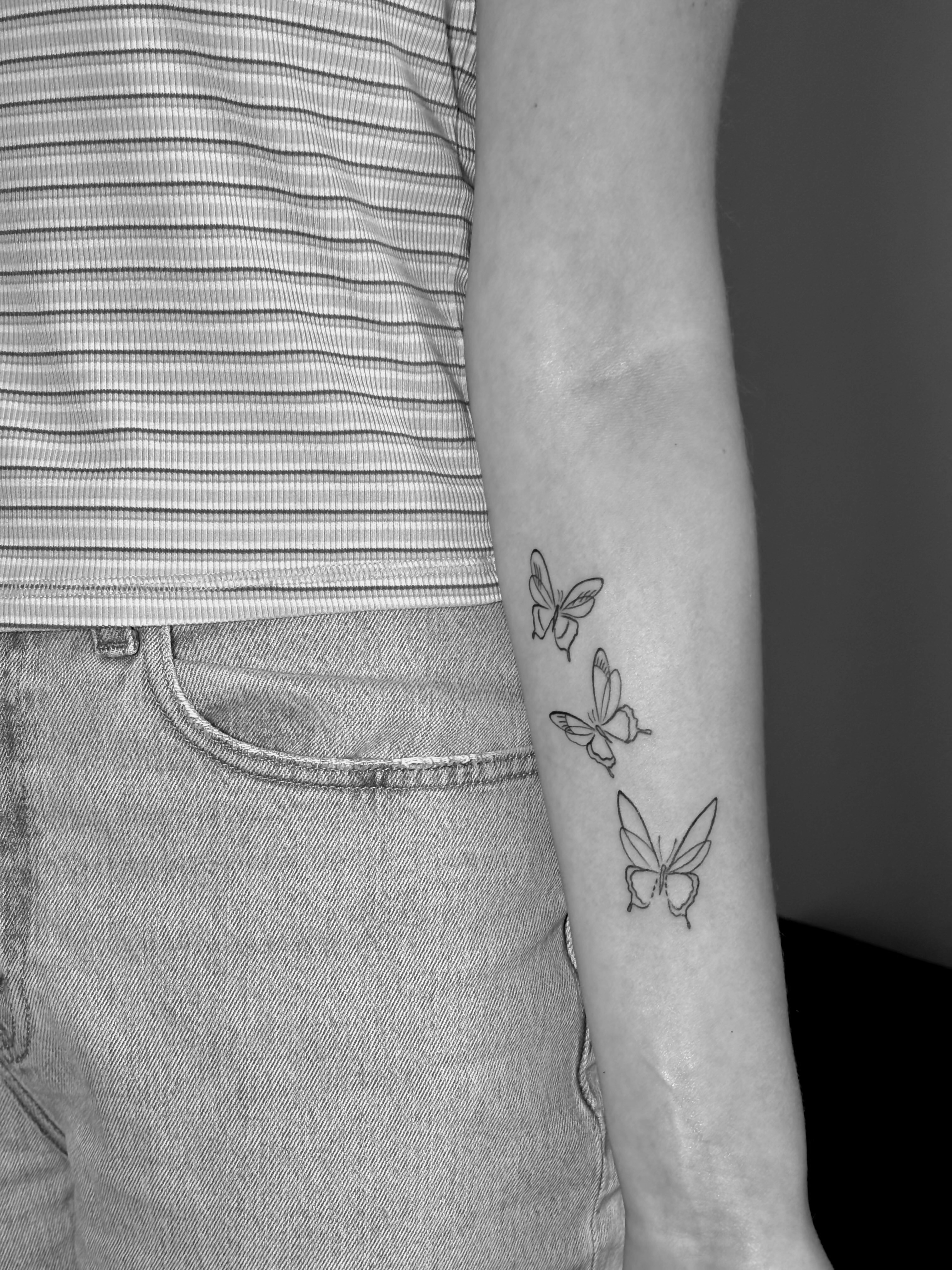 Three butterflies tattoo on arm