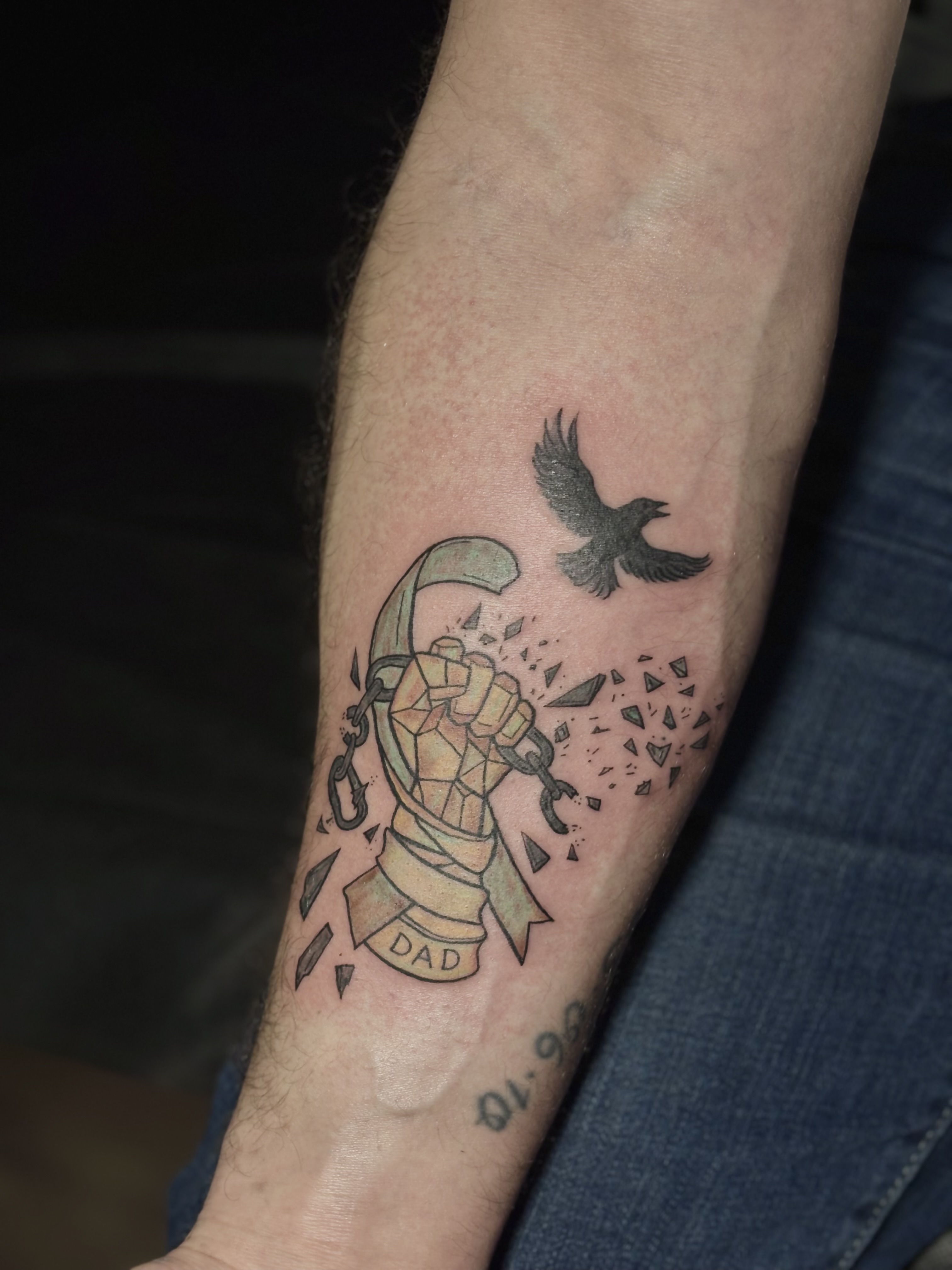 Dad fist with bird tattoo on arm