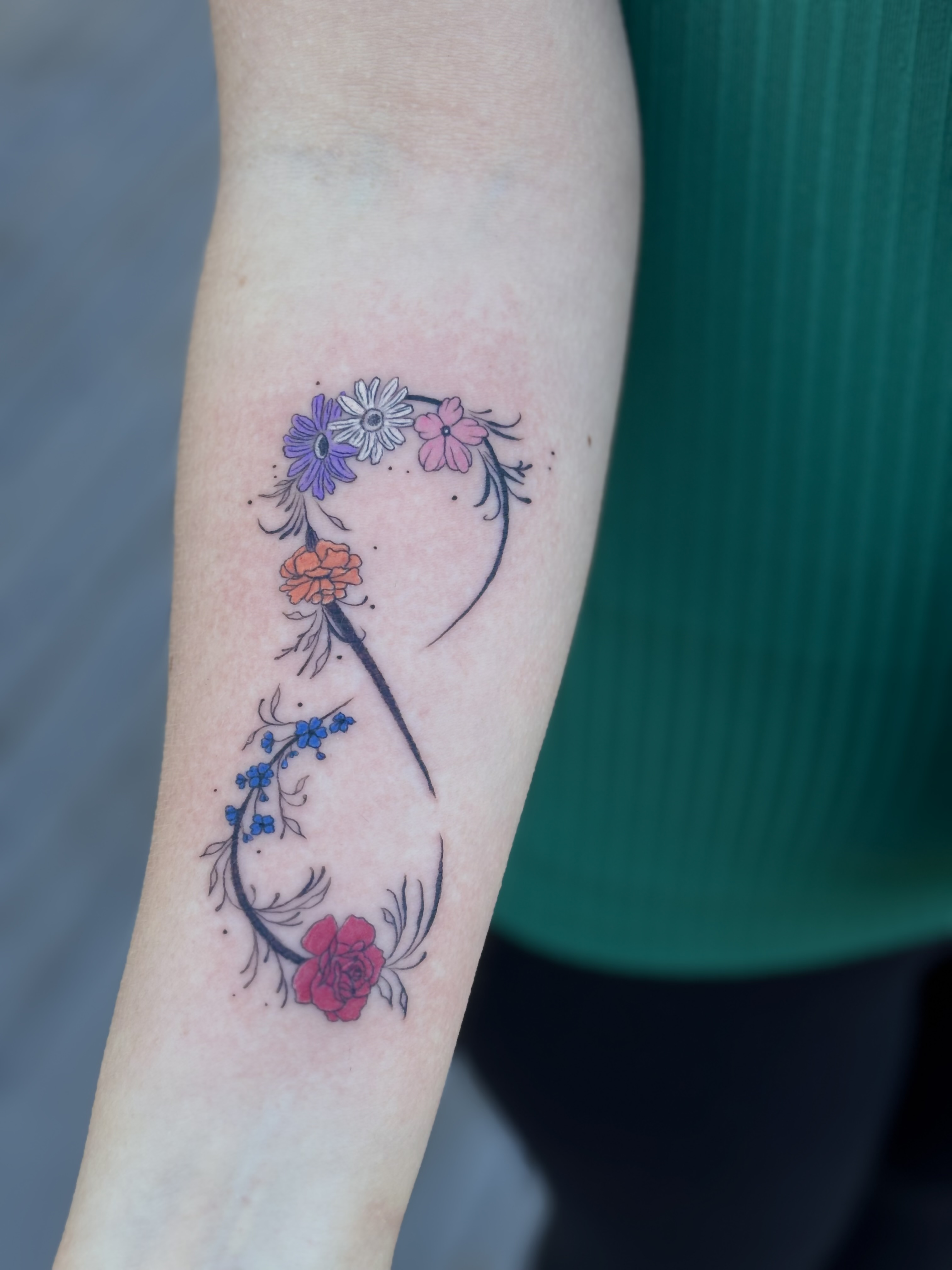 Color floral design tattoo on arm