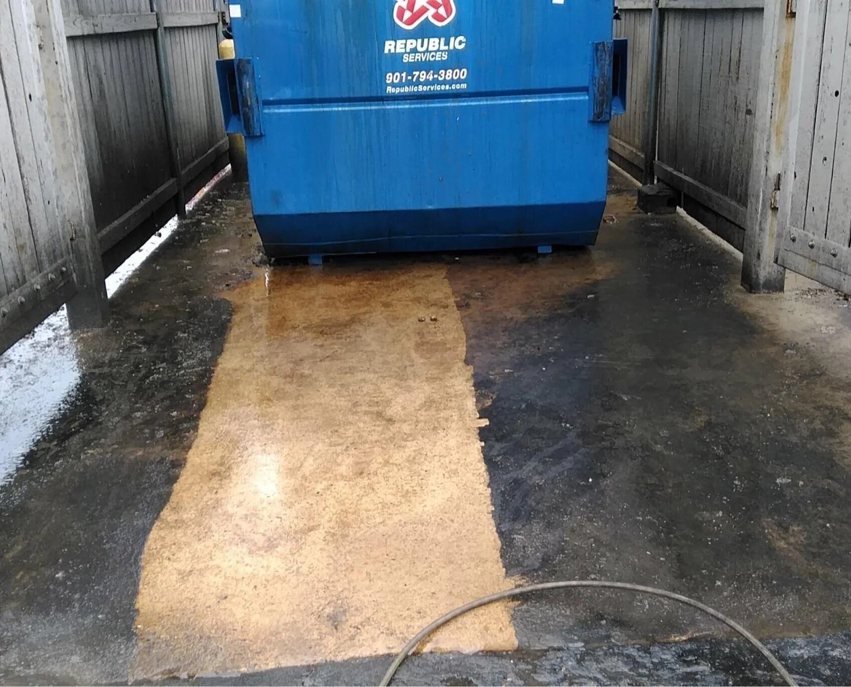 Dumpster pad cleaning in progress