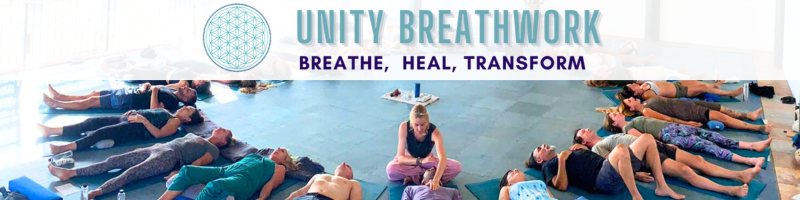 Breathwork class in a bright studio; participants lie on mats around a seated facilitator, with a banner reading 'Unity Breathwork: Breathe, Heal, Transform'