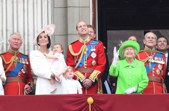 The Duchess of Cambridge, Kate, with Princess Charlotte in her arms, Prince George, Prince William, Queen Elizabeth II and Prince Philippe enjoy the air show from the balcony of Buckingham Palace