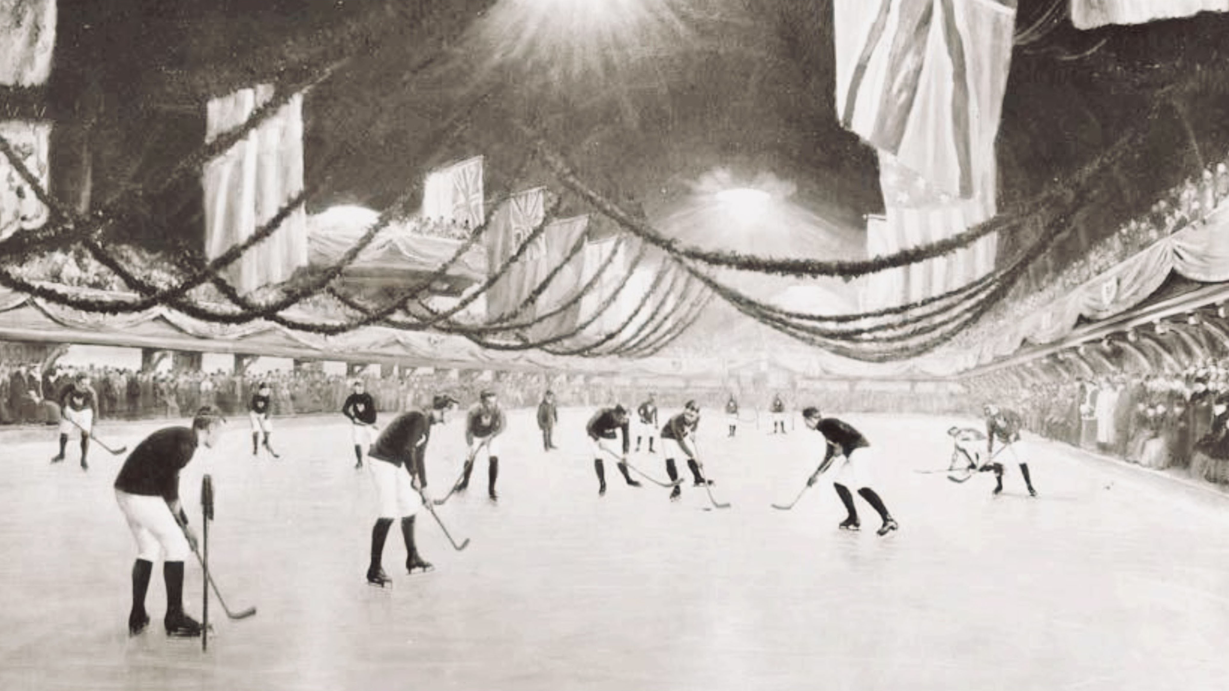 Early indoor ice hockey game at a large rink with players competing in front of spectators in the late 19th century