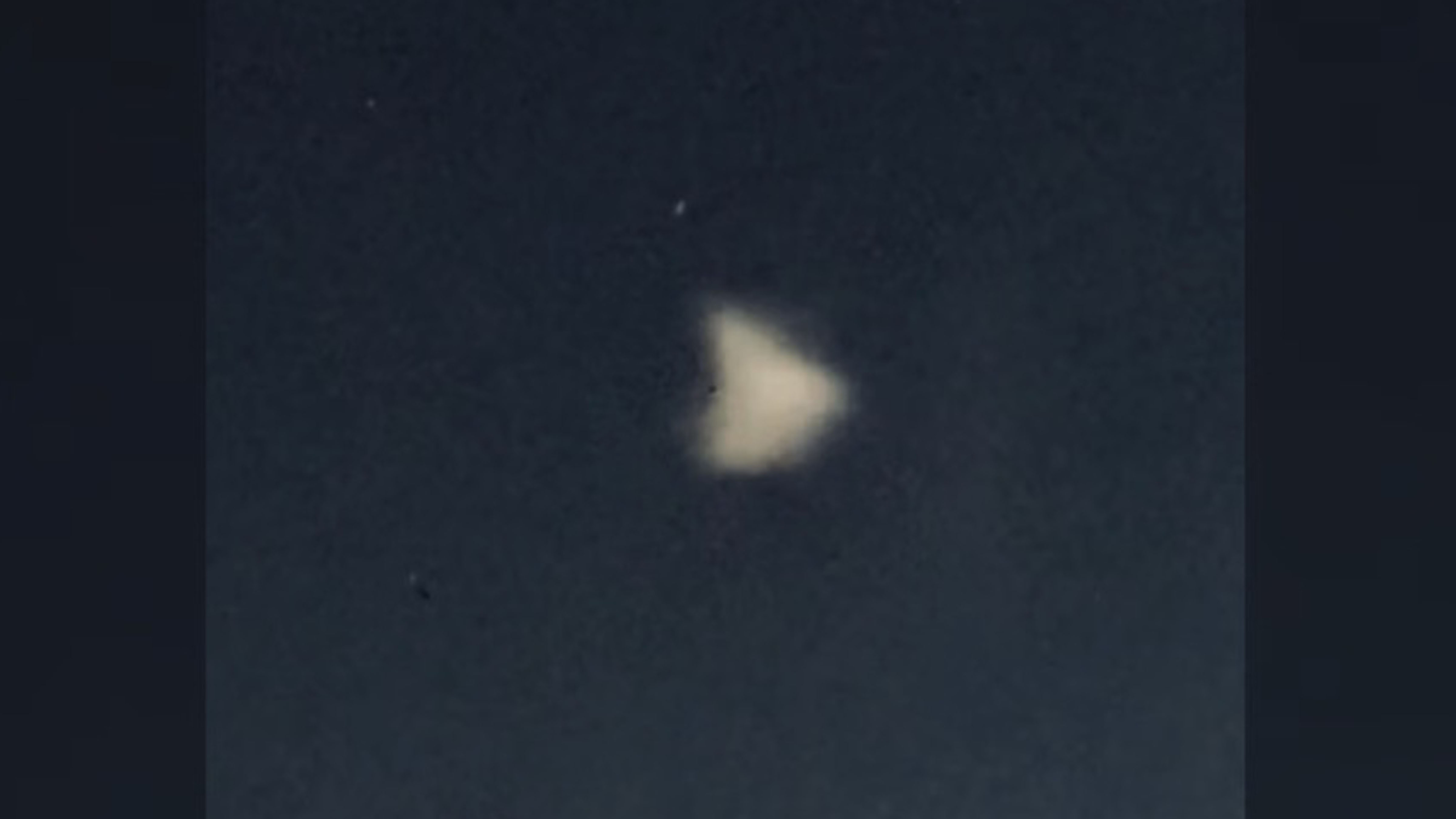 Blurry triangular light object glowing in the night sky above Northern British Columbia during reported May 2026 UAP sightings.