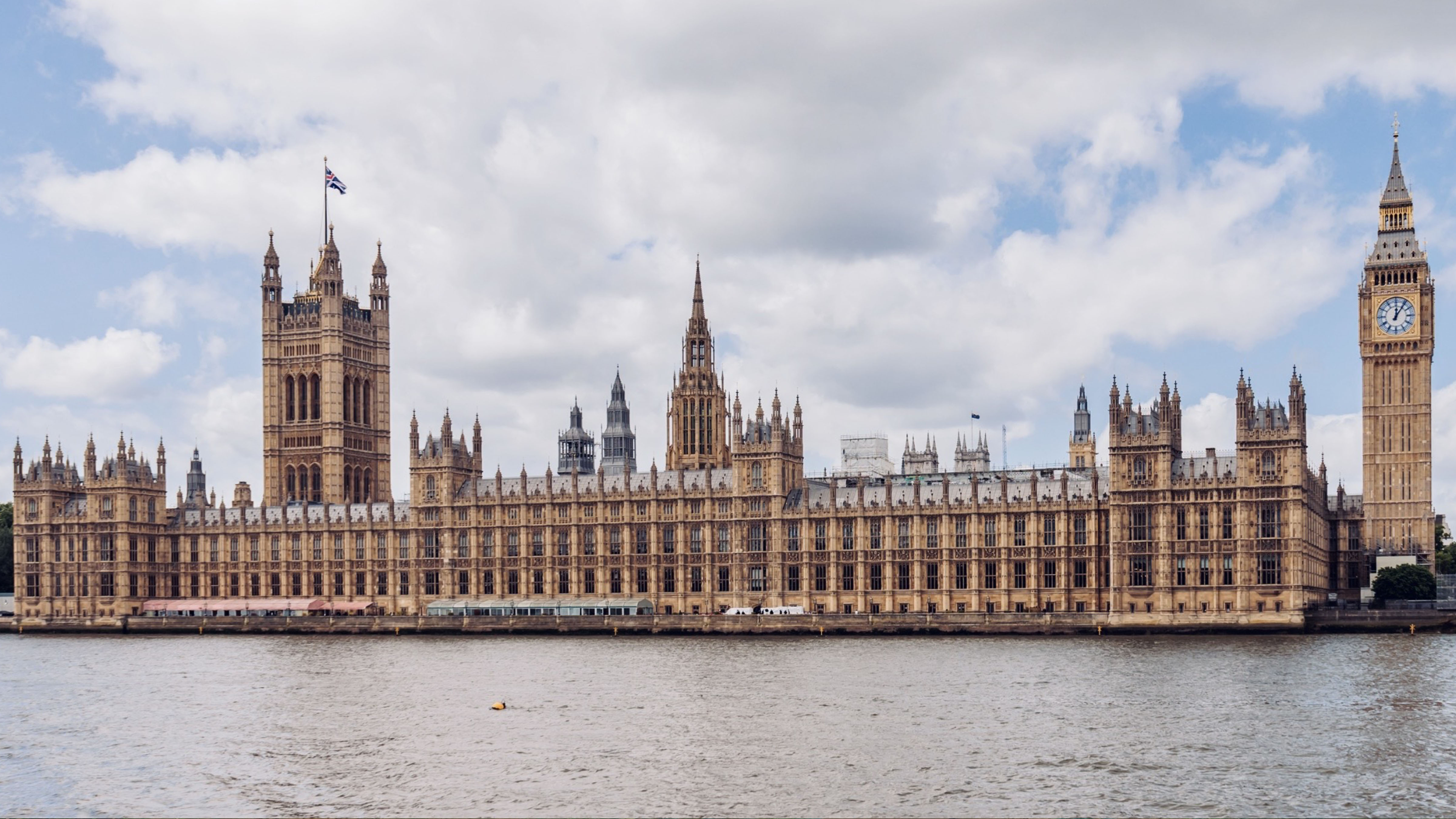 Big Ben and the Palace of Westminster standing along the River Thames in London, England.
