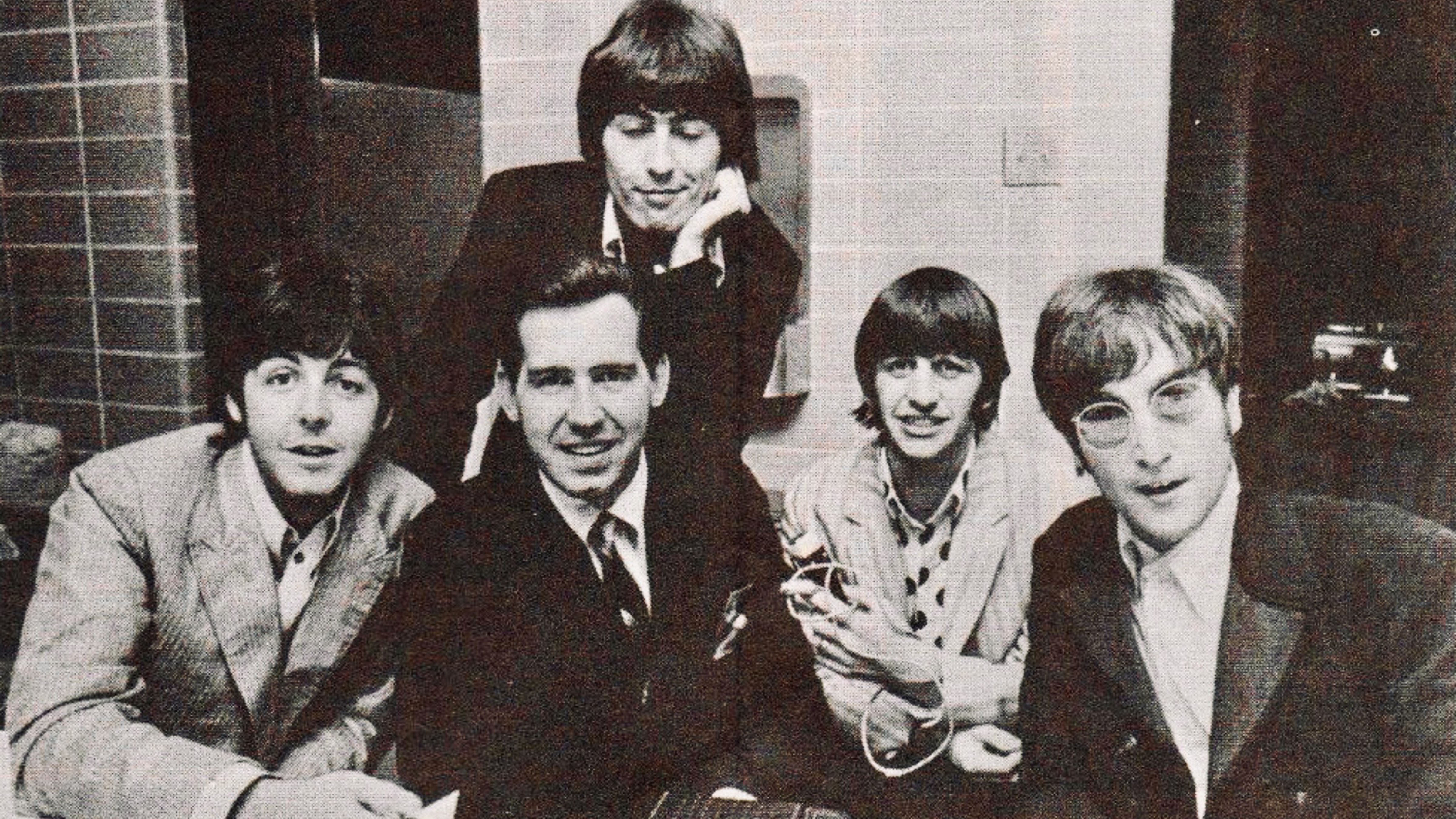 The Beatles pose with Chicago radio personality Jim Stagg during their final concert tour in August 1966.