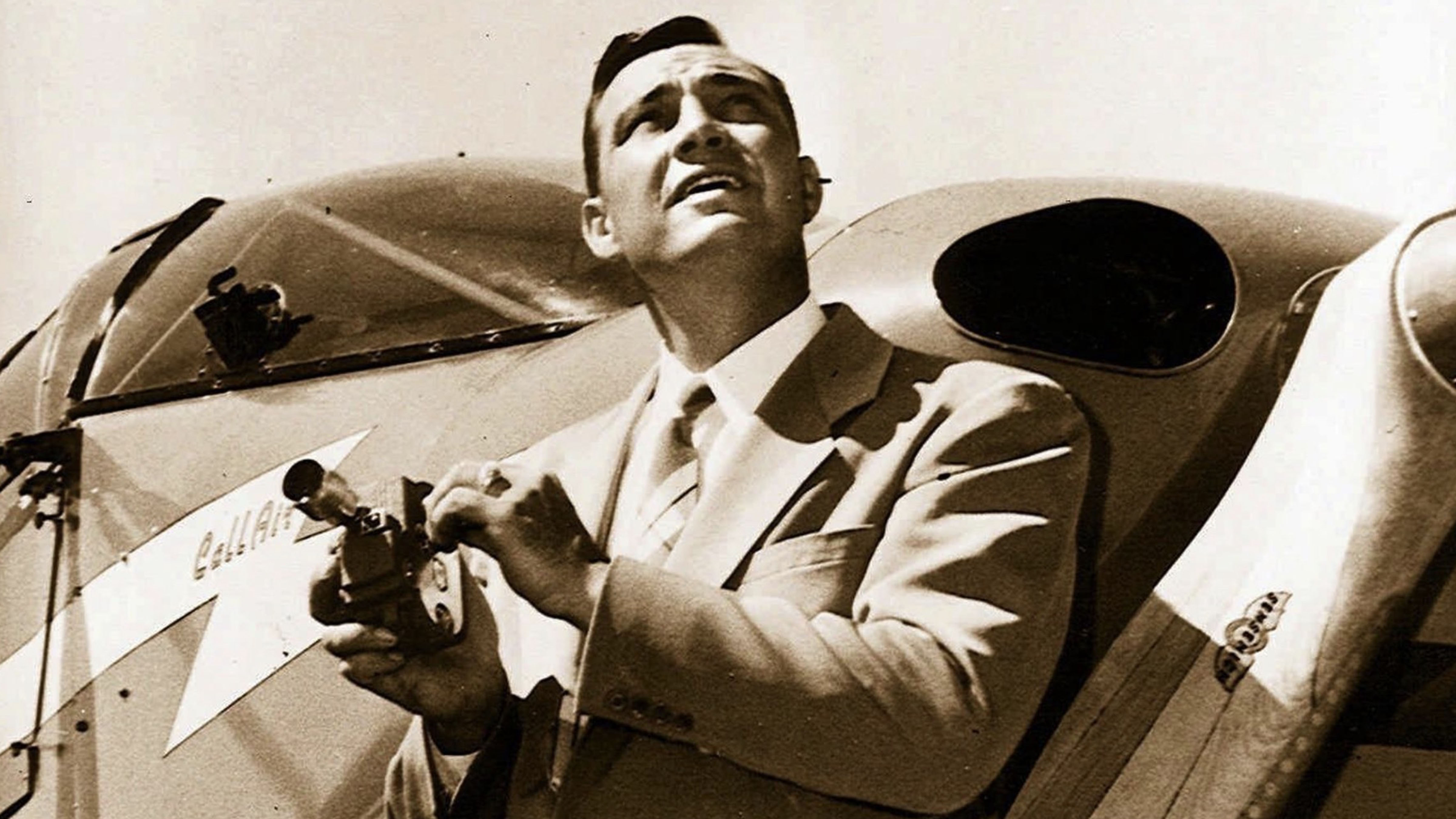 Pilot Kenneth Arnold stands beside his aircraft in 1947 after reporting a sighting of unusual objects near Mount Rainier, Washington.