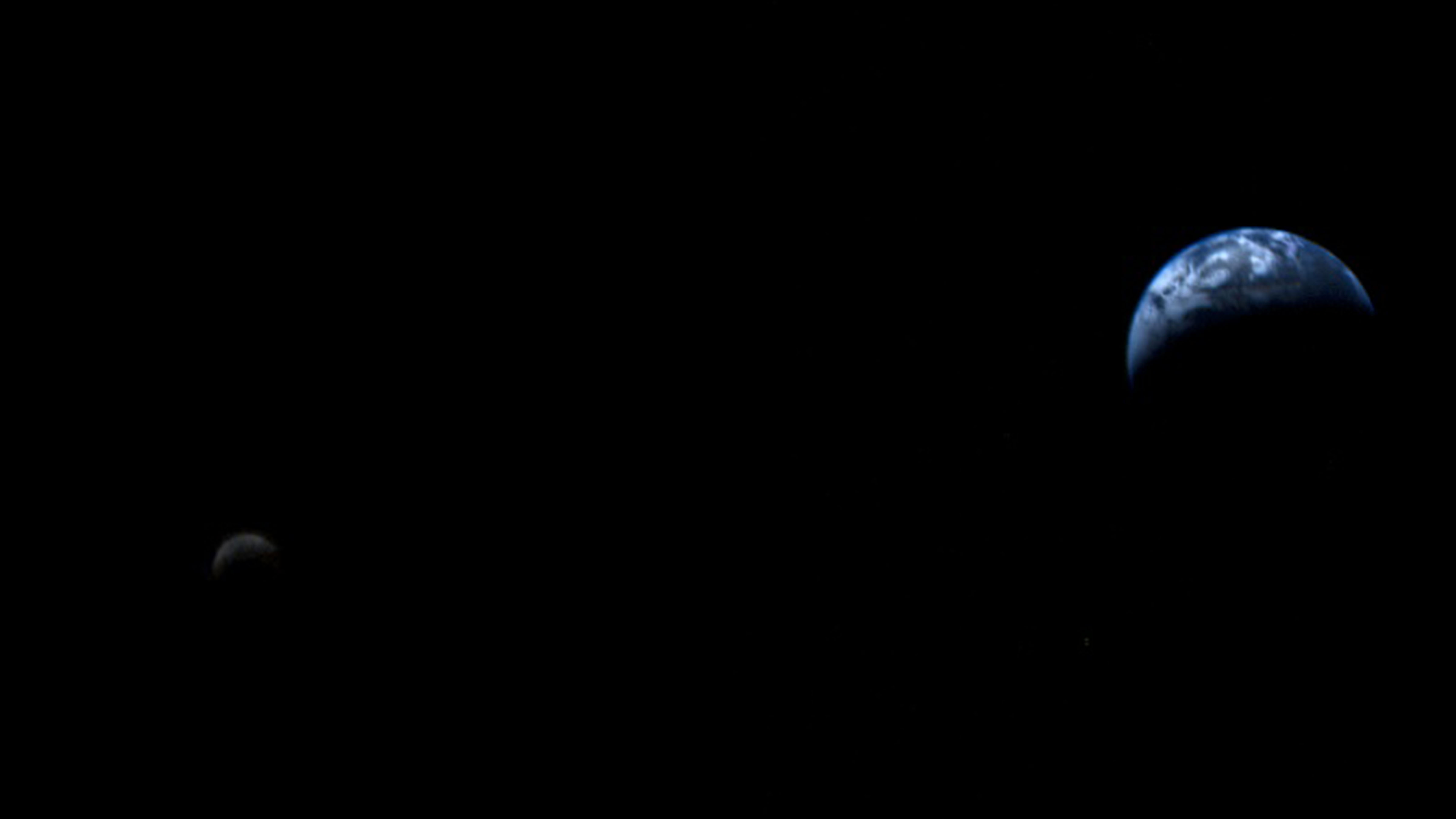 Voyager 1 photograph showing the crescent Earth and Moon together from millions of miles away on September 18, 1977.