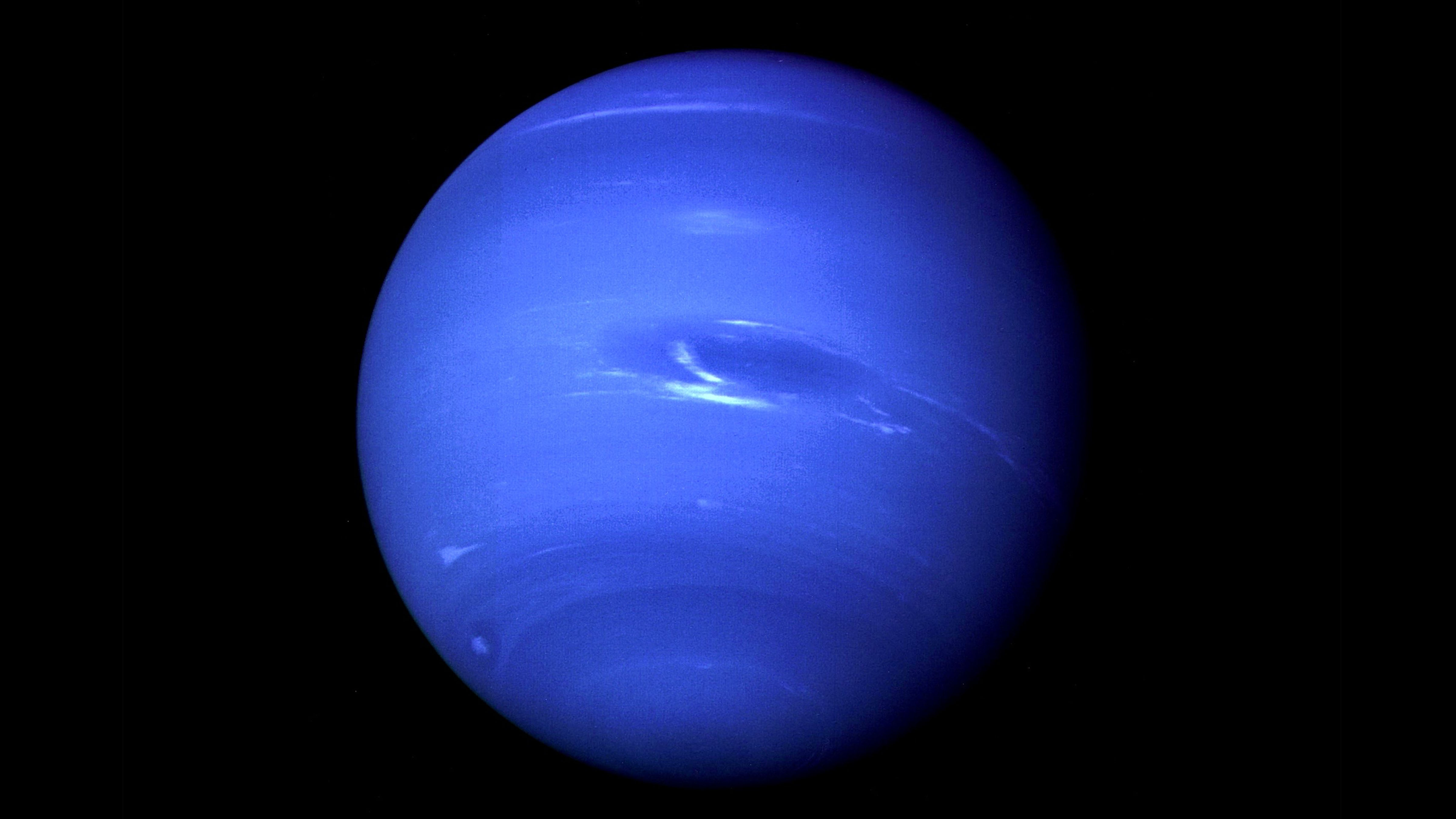 Neptune photographed by NASA’s Voyager 2 spacecraft in 1989, showing the planet’s blue atmosphere and Great Dark Spot.