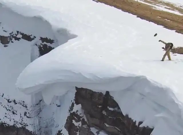 Massive cornice break triggered by skier throwing rocks.